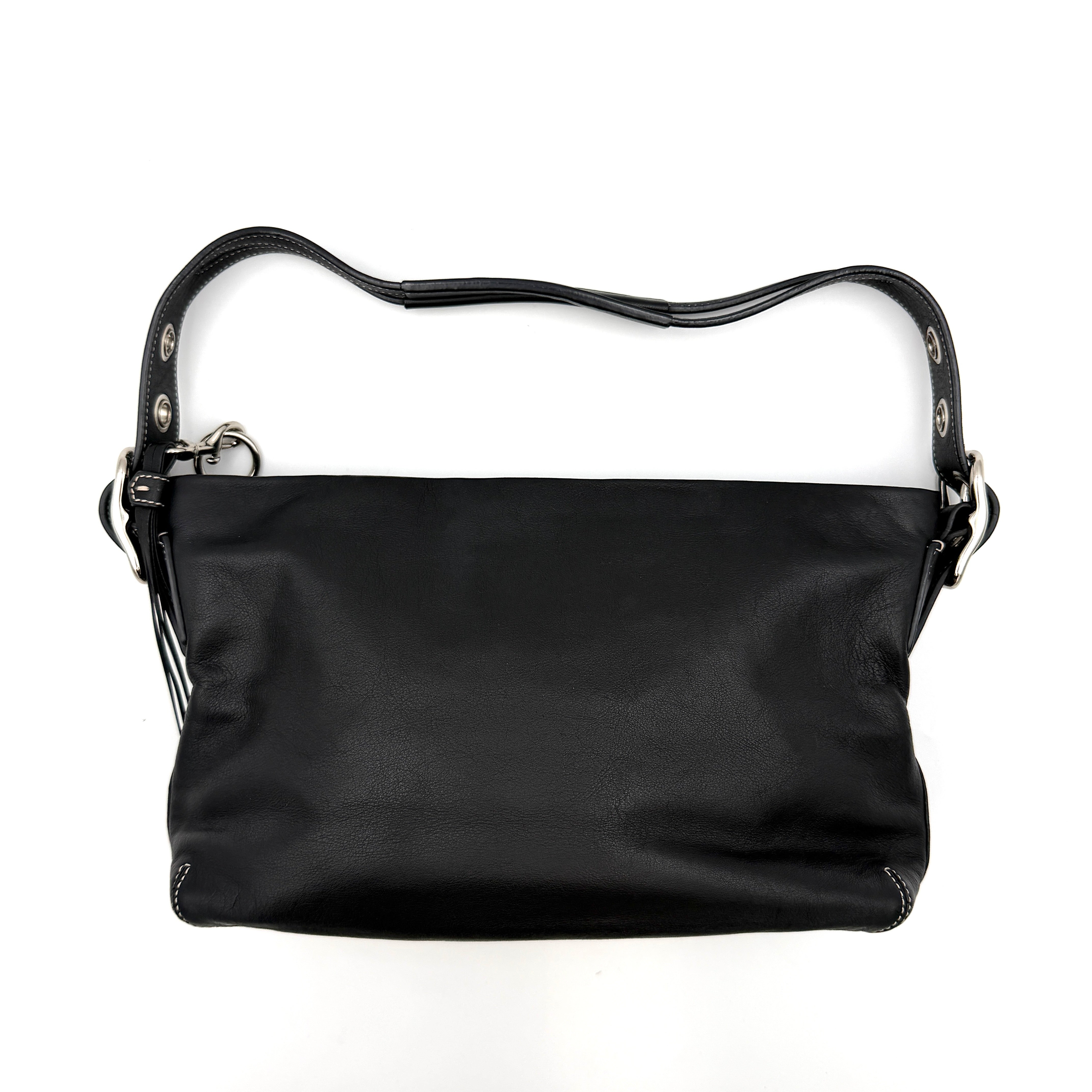 Coach Signature East West Shoulder Bag in black leather with silver hardware and contrast stitching, displayed on a white background.