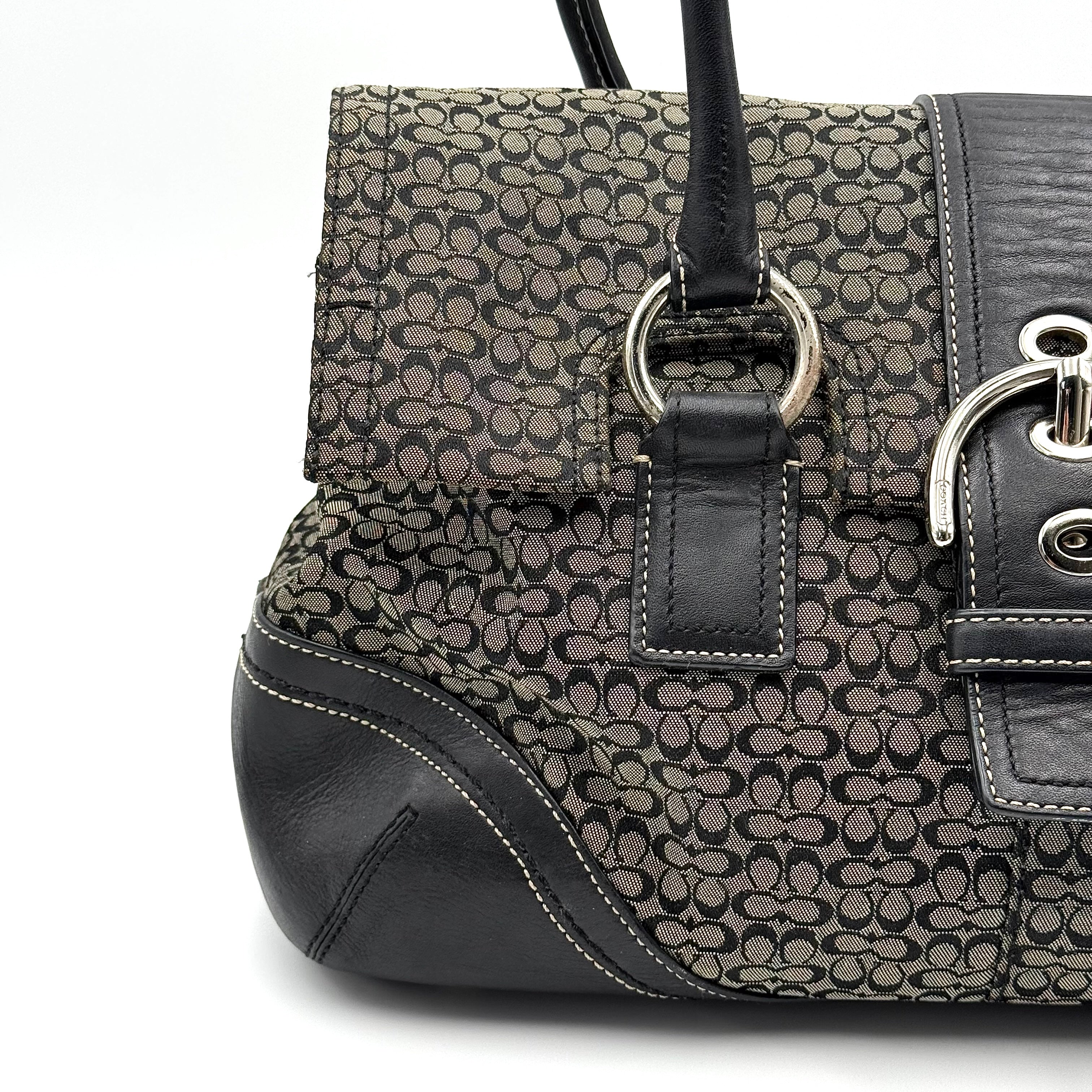 Coach Soho shoulder bag in grey and black jacquard with leather trim and silver hardware, presented with double top handles.