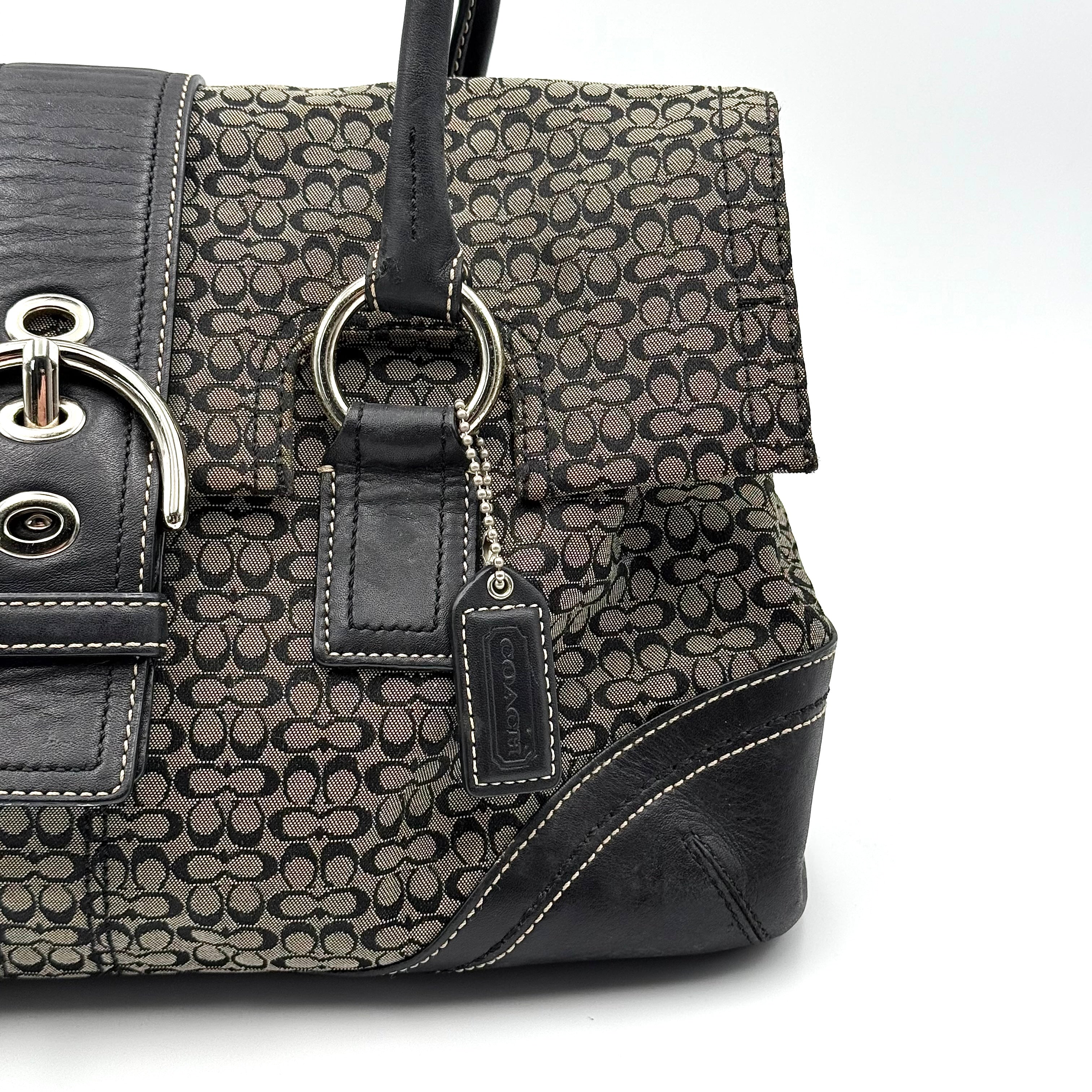 Coach Soho shoulder bag in grey and black jacquard with leather trim and silver hardware, presented with double top handles.