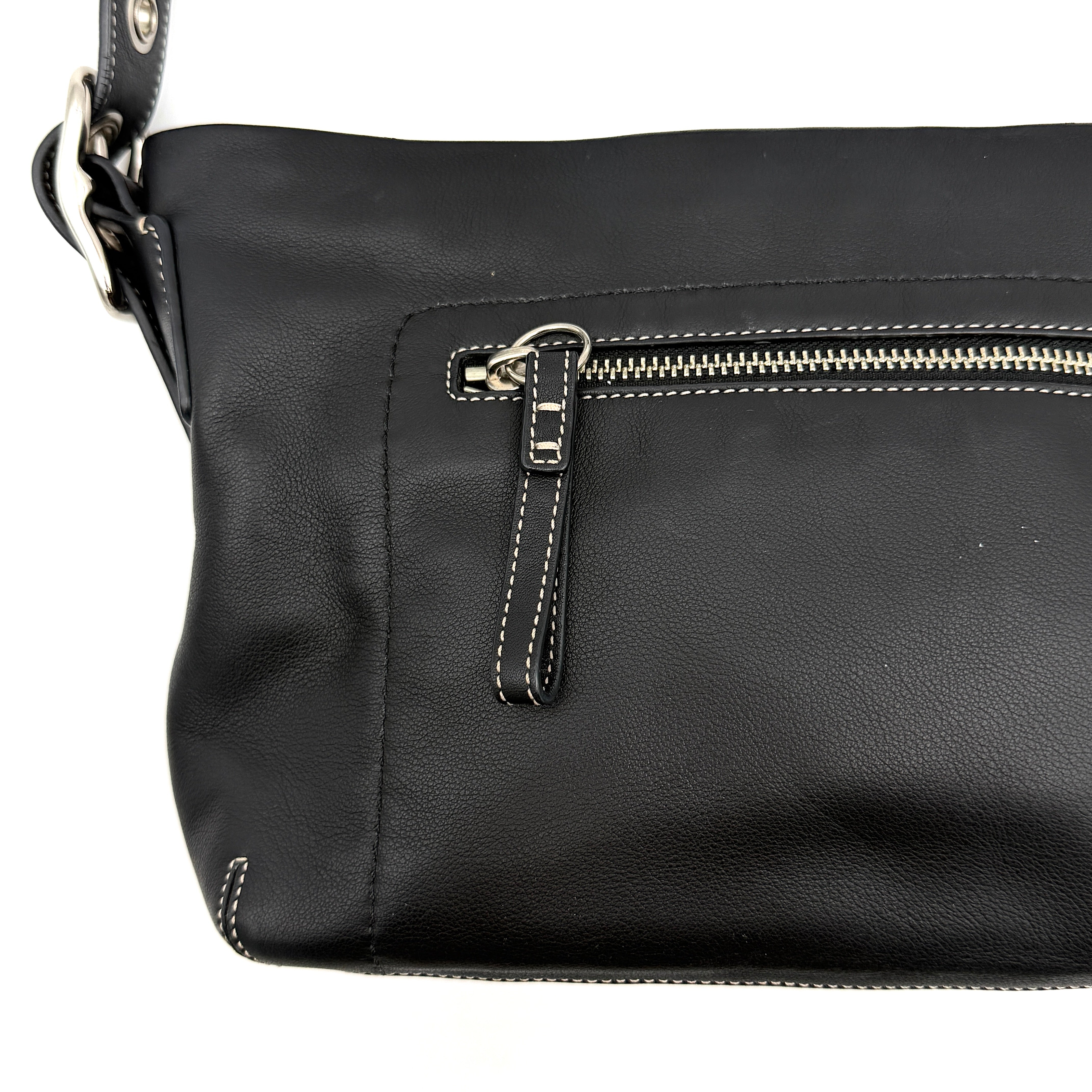 Coach Signature East West Shoulder Bag in black leather with silver hardware and contrast stitching, displayed on a white background.