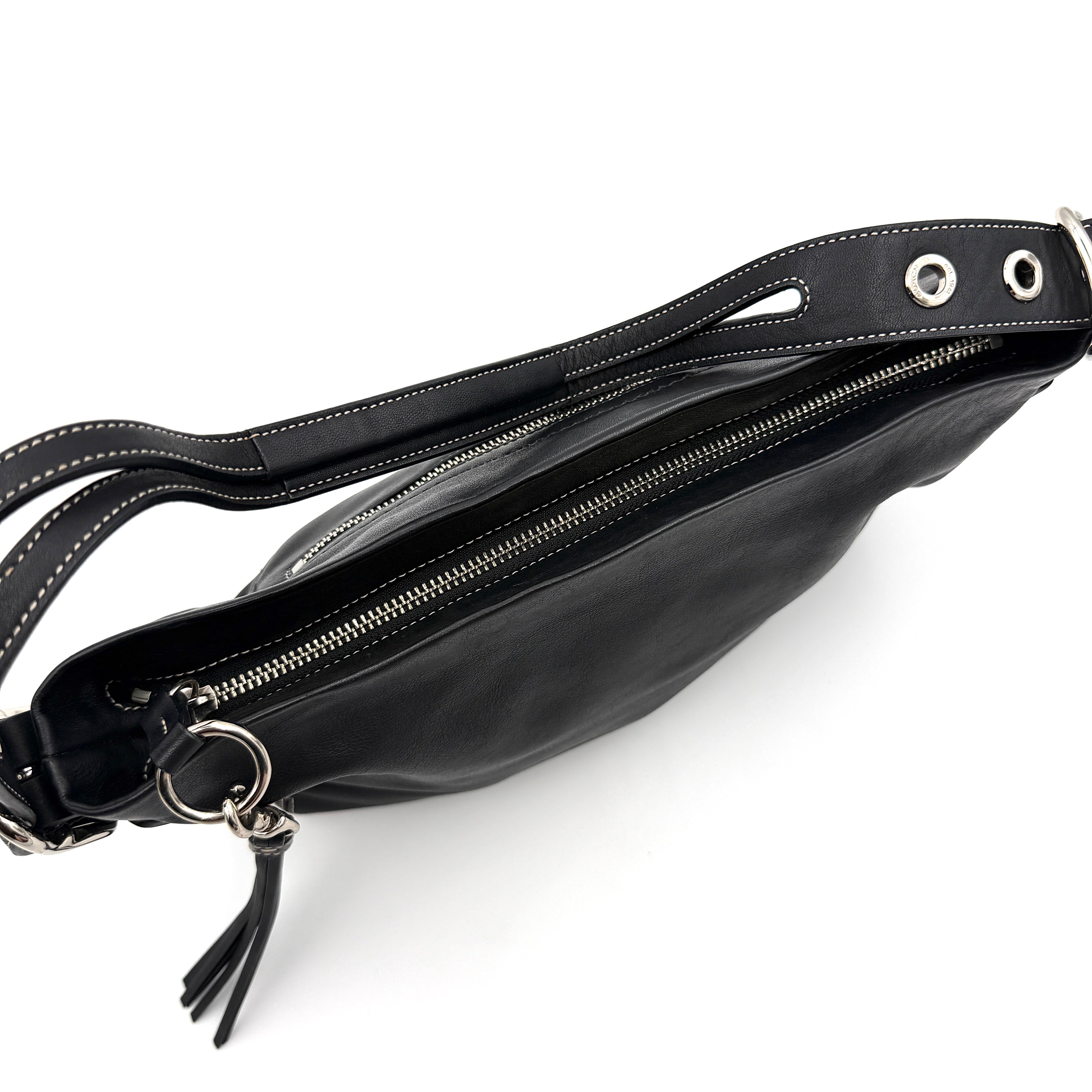 Coach Signature East West Shoulder Bag in black leather with silver hardware and contrast stitching, displayed on a white background.