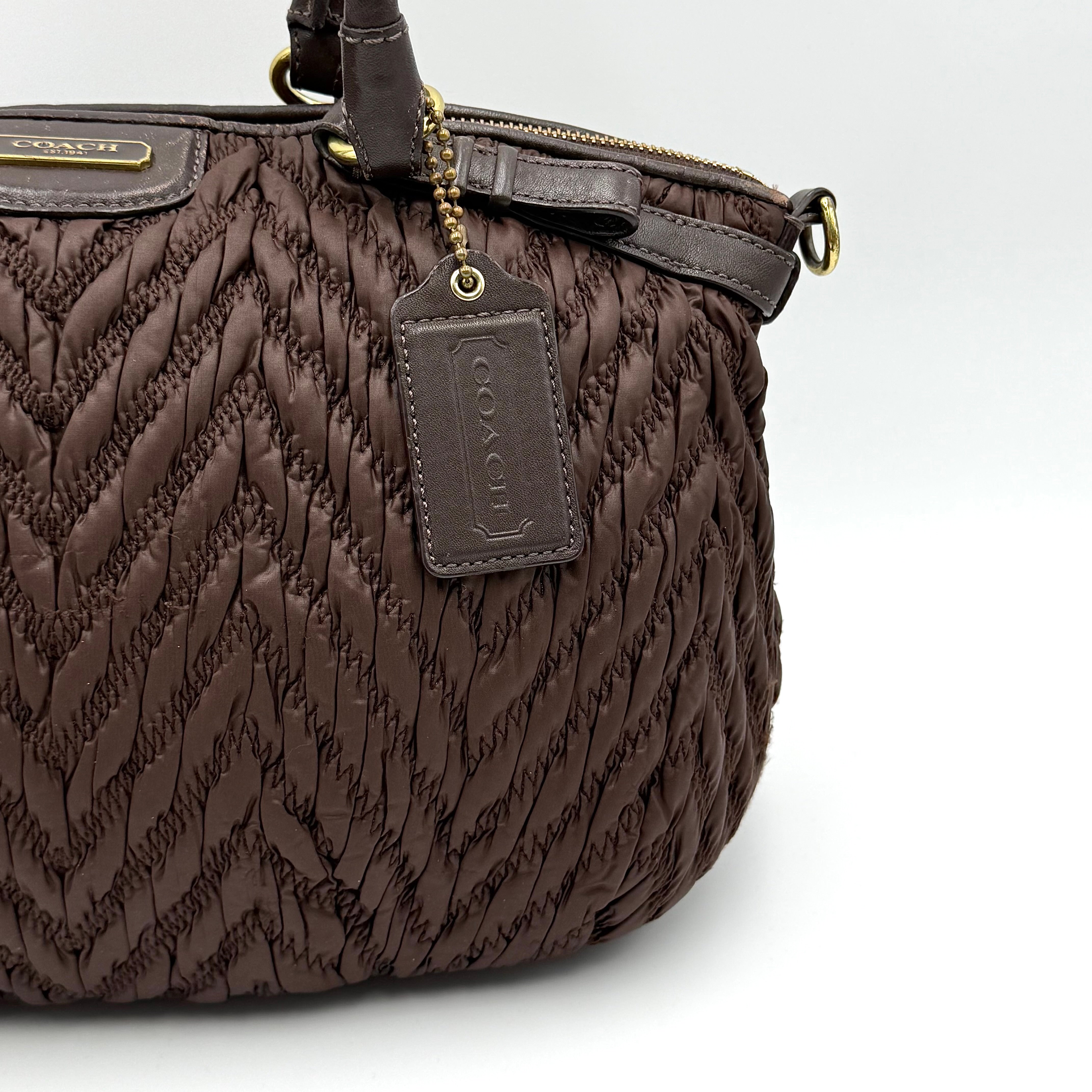 Front view of the Coach Madison Chevron 2Way brown quilted nylon shoulder bag with rolled leather handles and gold-tone hardware.