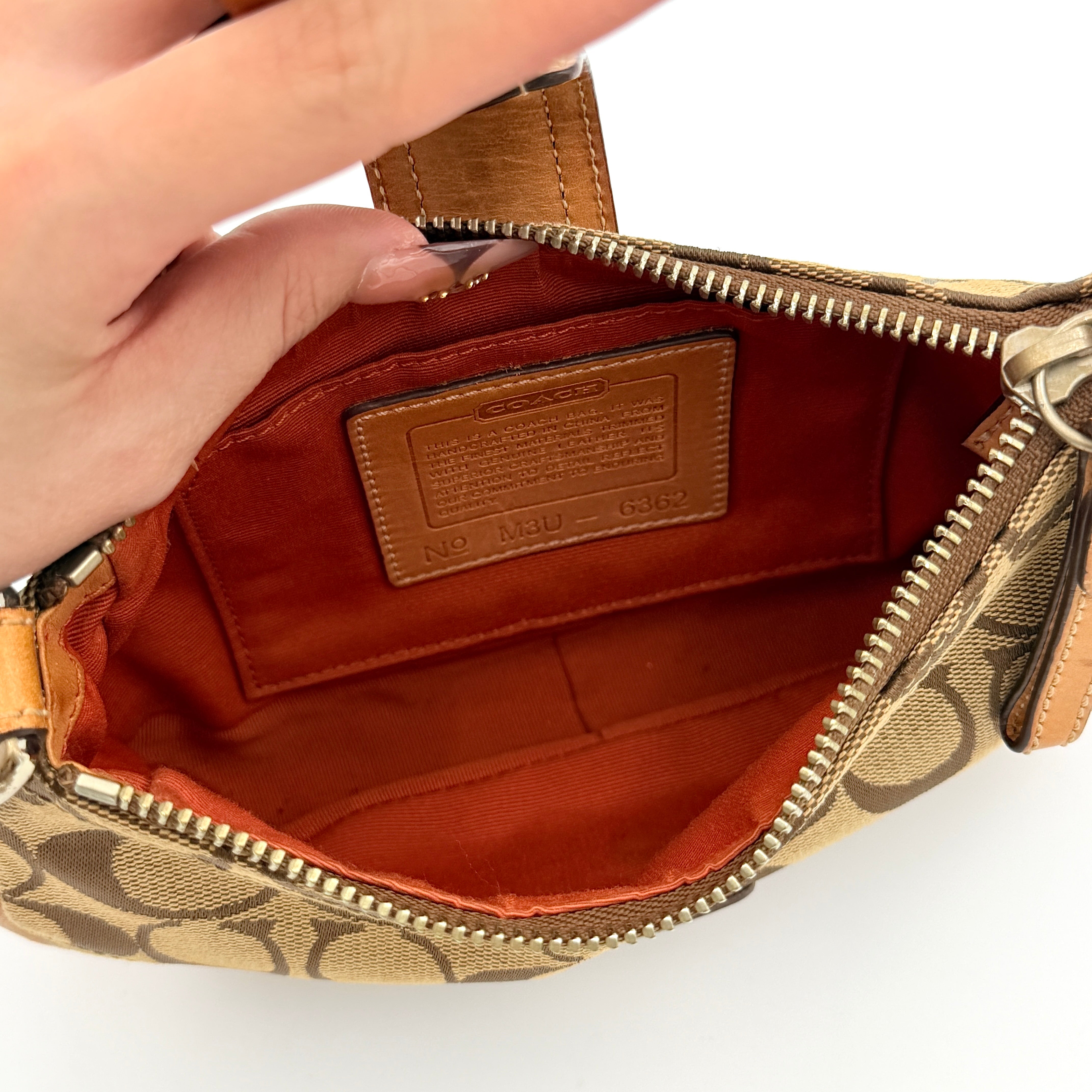 Coach Soho Demi shoulder bag in beige signature canvas with tan leather trim and silver hardware, shown with matching hangtag.