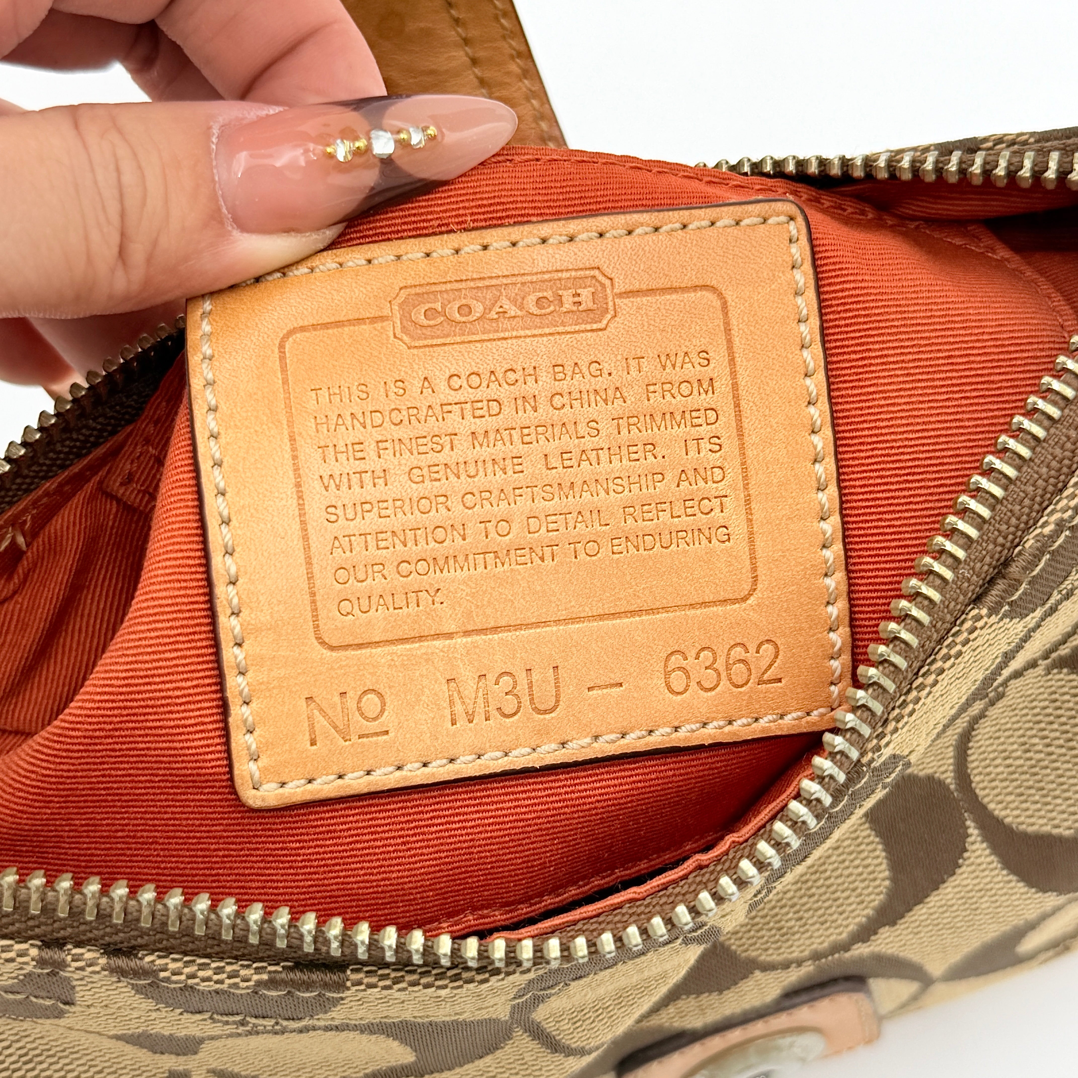 Coach Soho Demi shoulder bag in beige signature canvas with tan leather trim and silver hardware, shown with matching hangtag.
