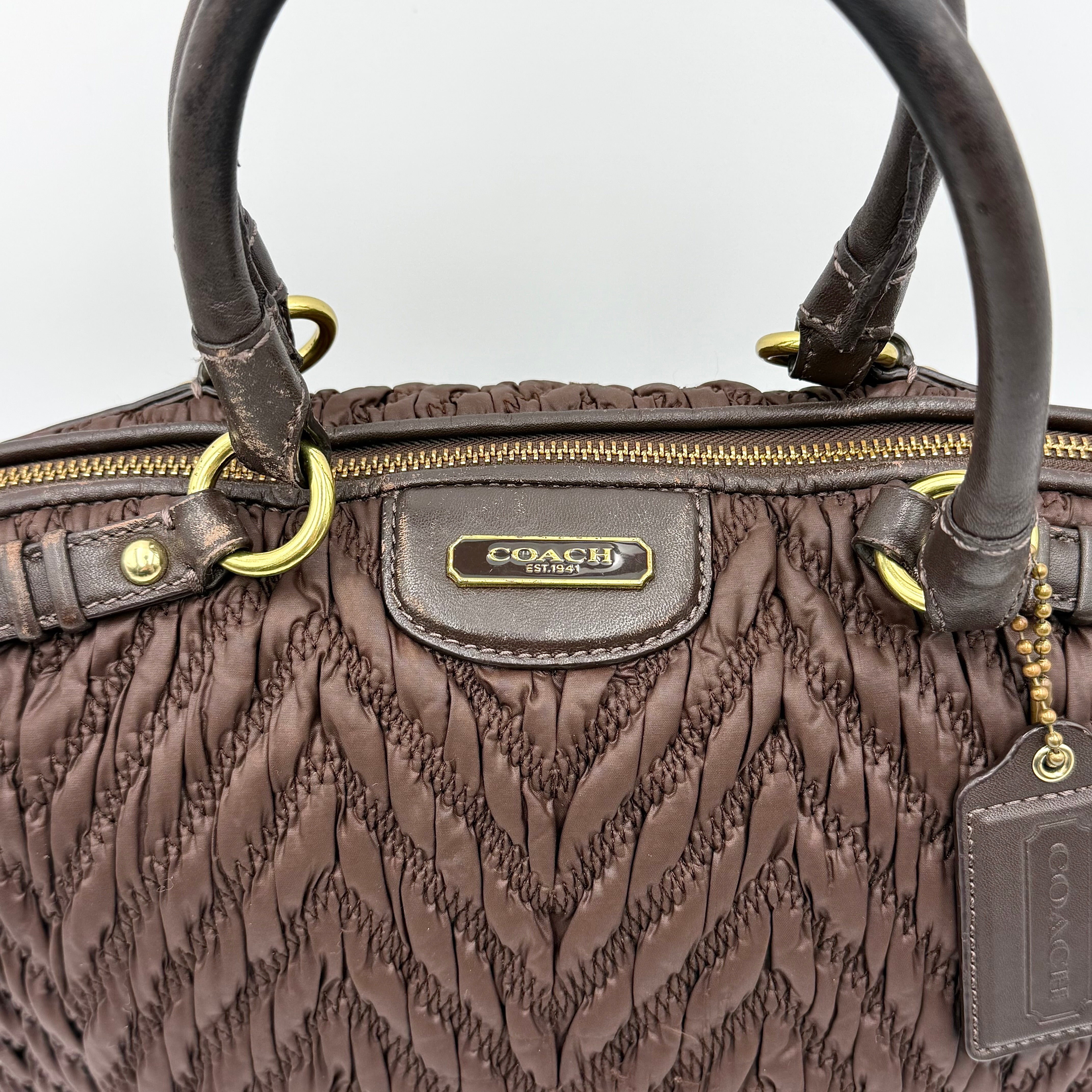 Front view of the Coach Madison Chevron 2Way brown quilted nylon shoulder bag with rolled leather handles and gold-tone hardware.