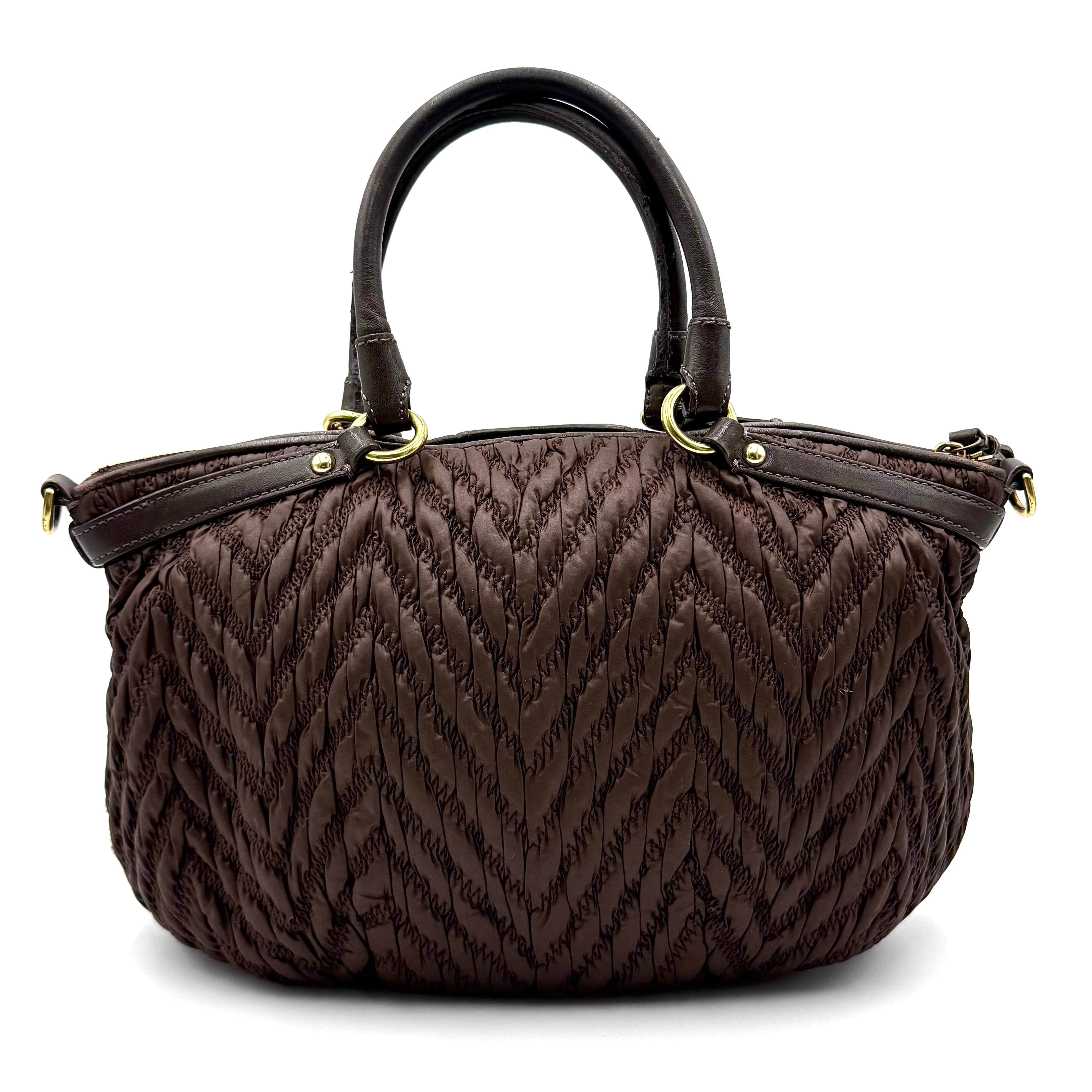 Front view of the Coach Madison Chevron 2Way brown quilted nylon shoulder bag with rolled leather handles and gold-tone hardware.