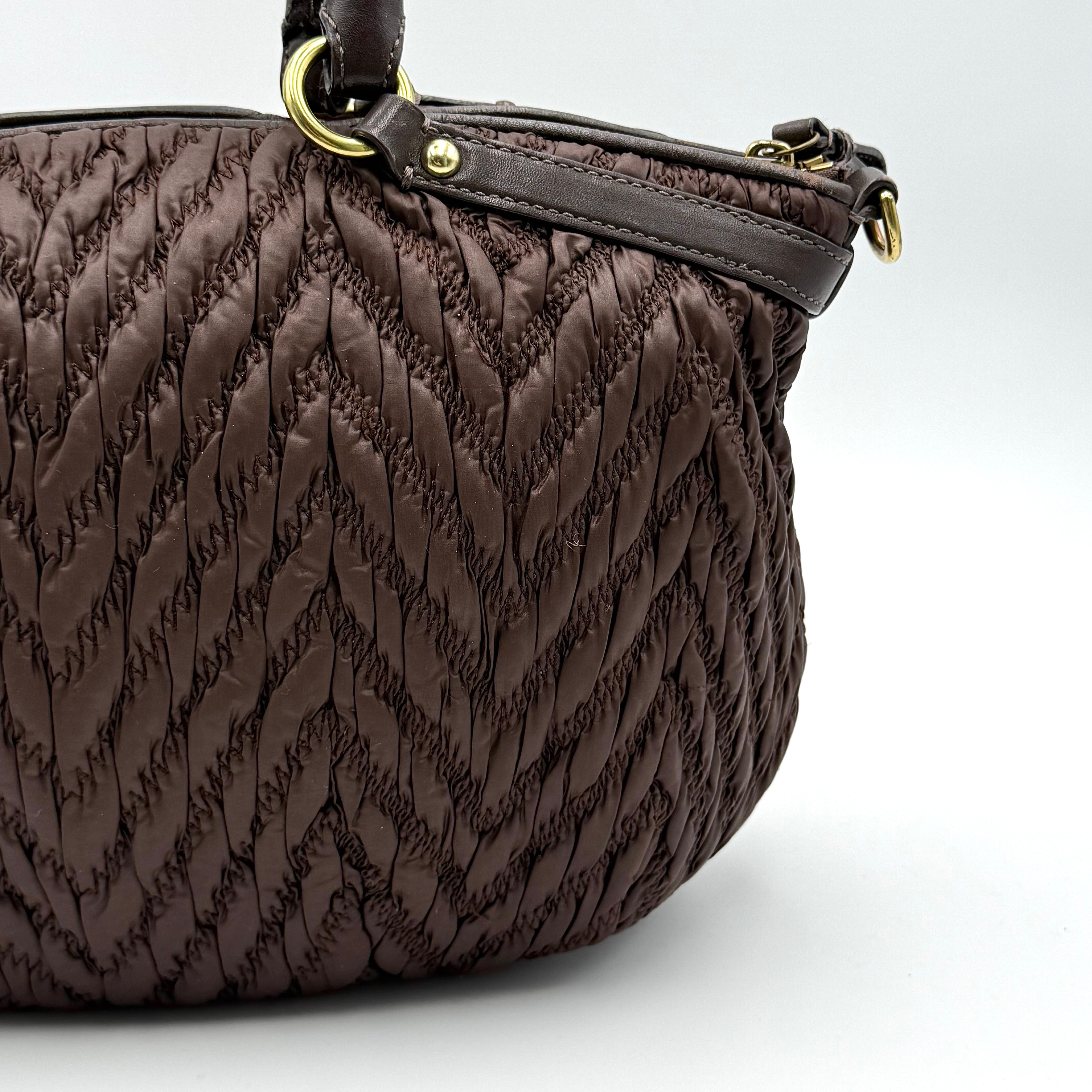Front view of the Coach Madison Chevron 2Way brown quilted nylon shoulder bag with rolled leather handles and gold-tone hardware.