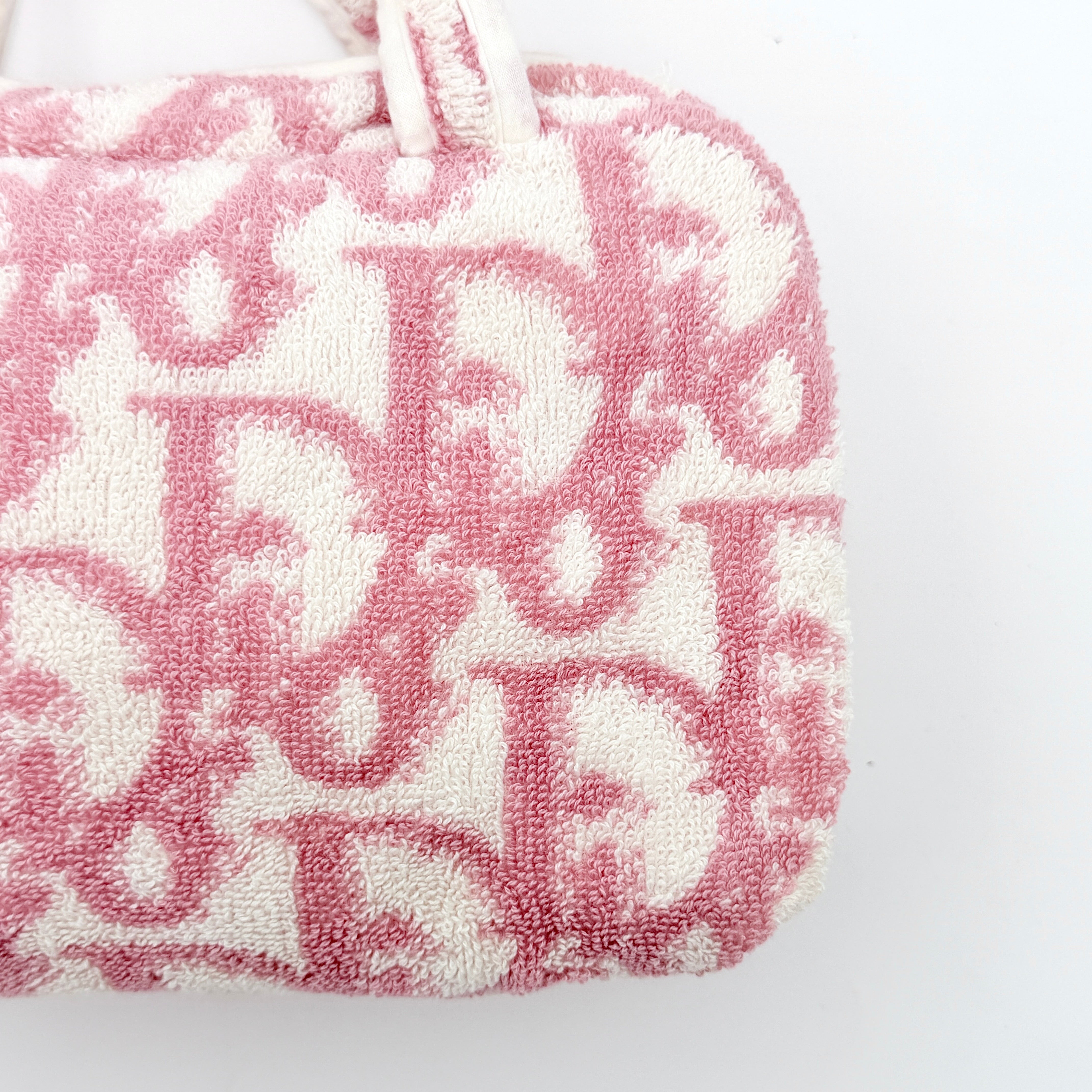 Christian Dior pink and white Trotter terry cloth mini bag with top handles and zip closure, displayed on a white background.