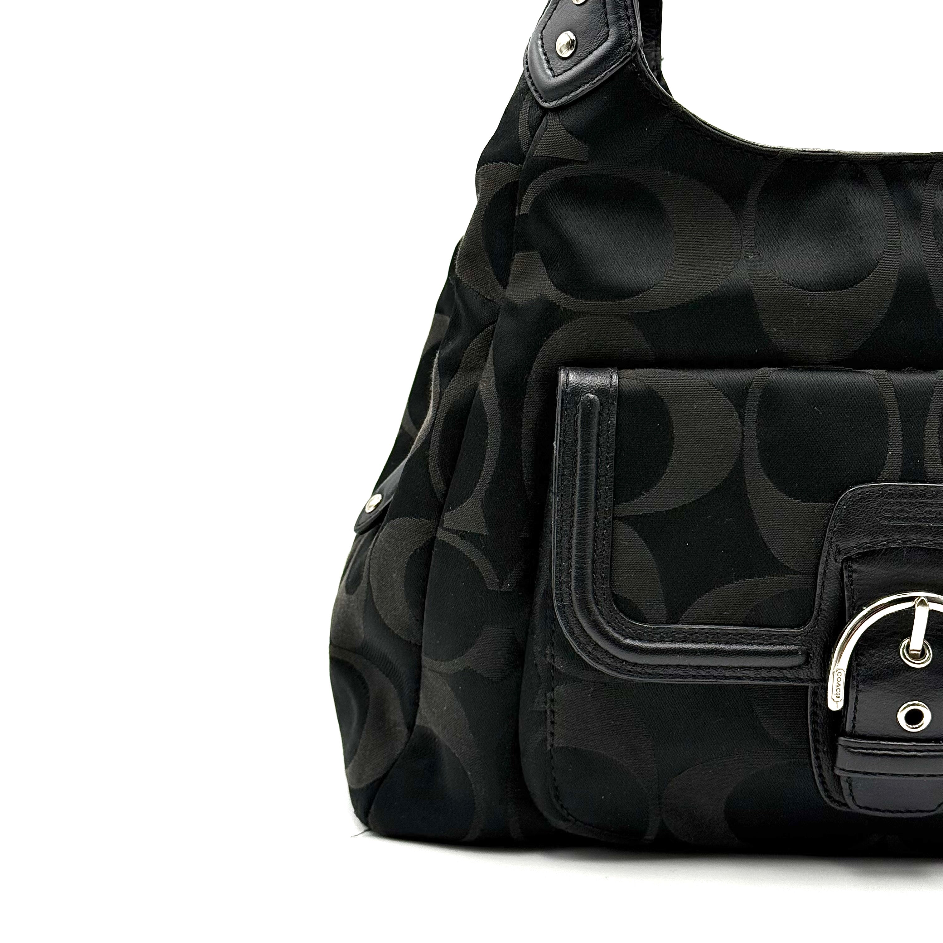 Coach Signature Campbell Hobo Shoulder Bag in black jacquard canvas with leather trim and front buckle pocket, photographed against a white background.
