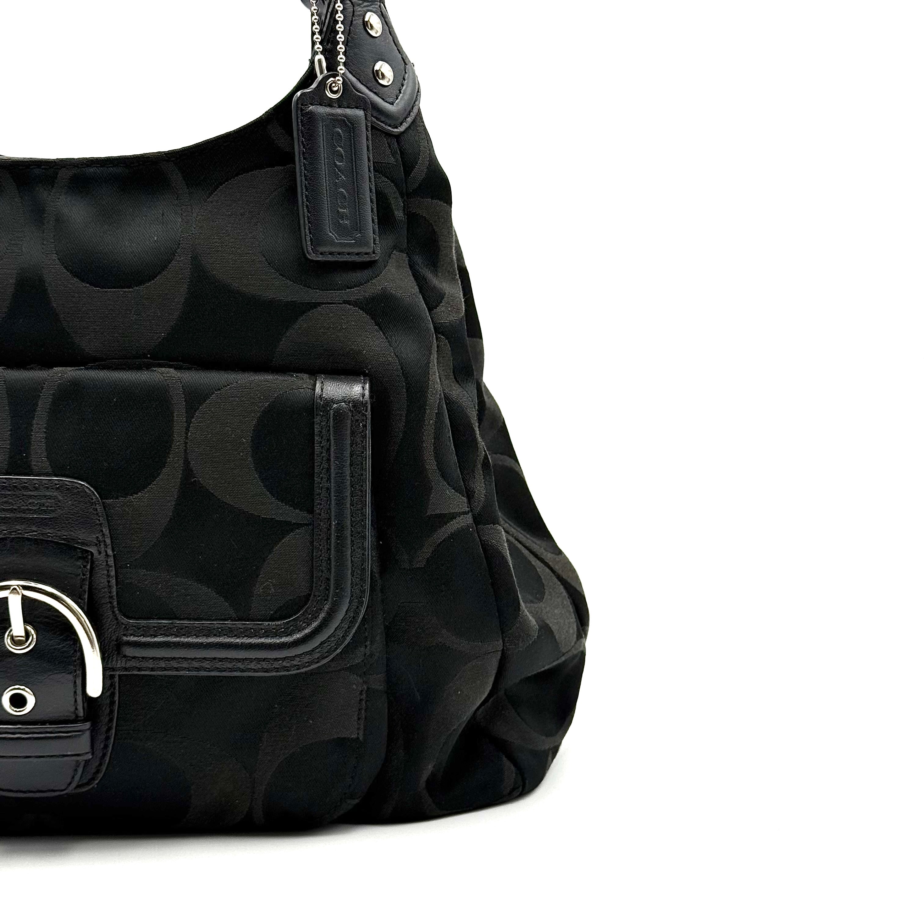 Coach Signature Campbell Hobo Shoulder Bag in black jacquard canvas with leather trim and front buckle pocket, photographed against a white background.