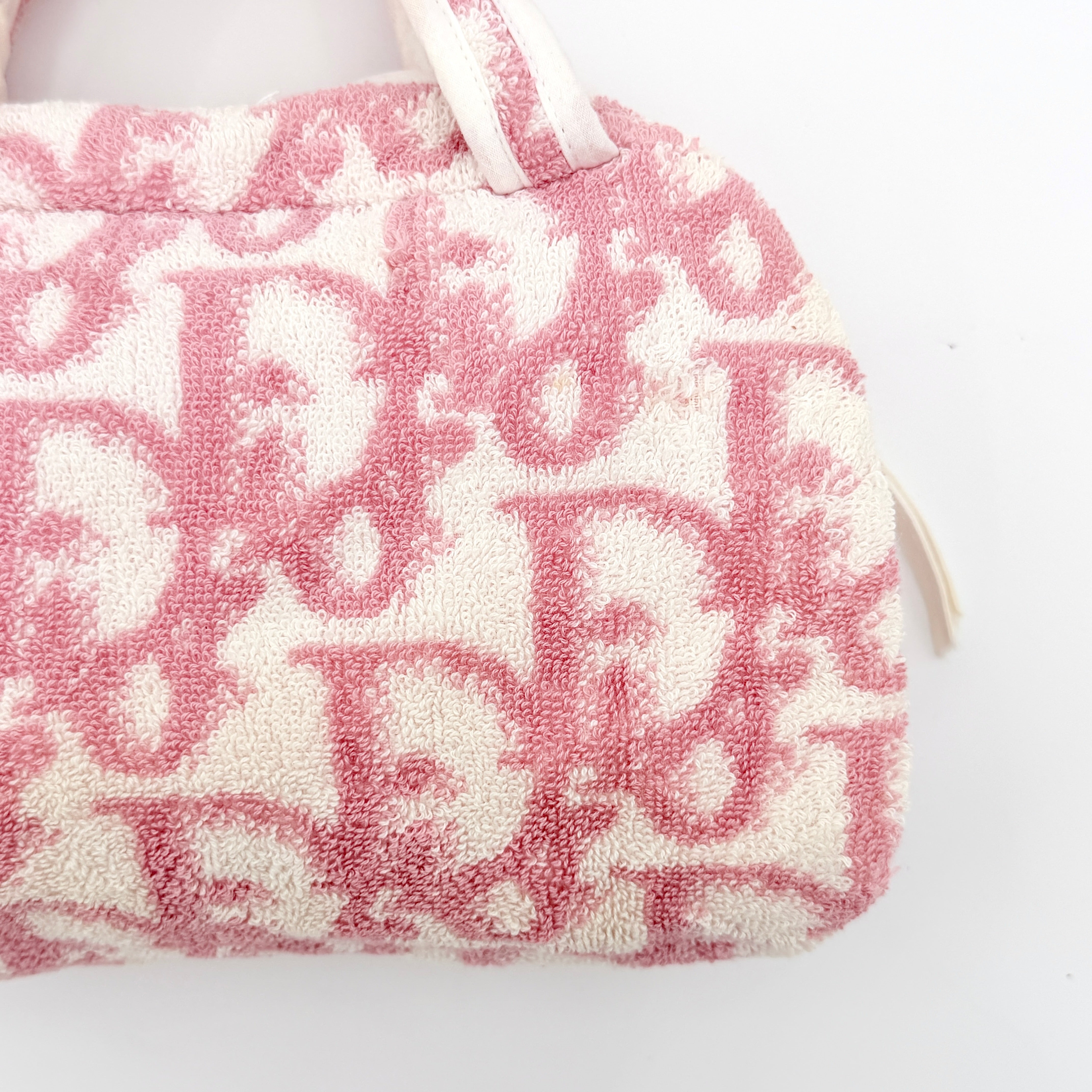 Christian Dior pink and white Trotter terry cloth mini bag with top handles and zip closure, displayed on a white background.