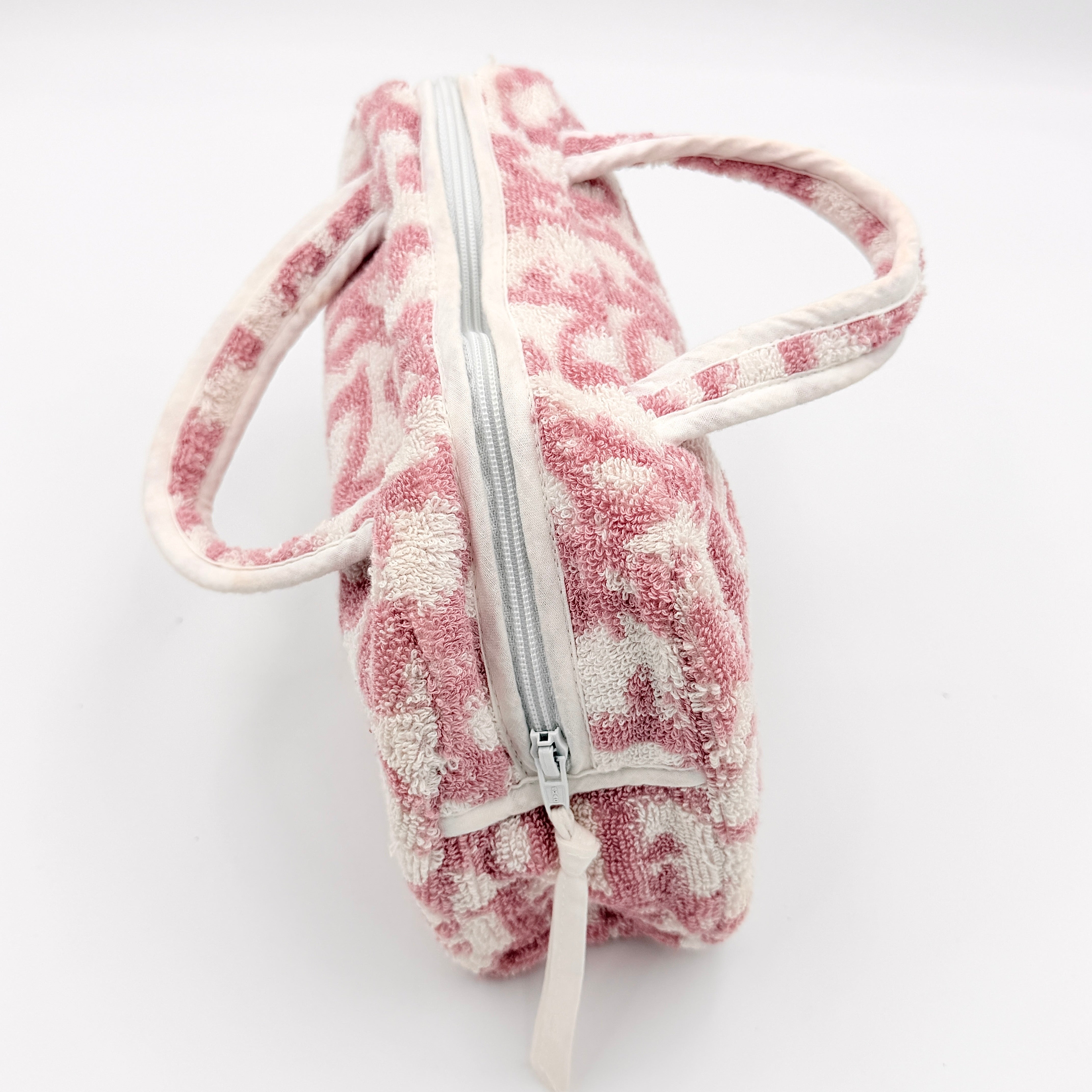 Christian Dior pink and white Trotter terry cloth mini bag with top handles and zip closure, displayed on a white background.