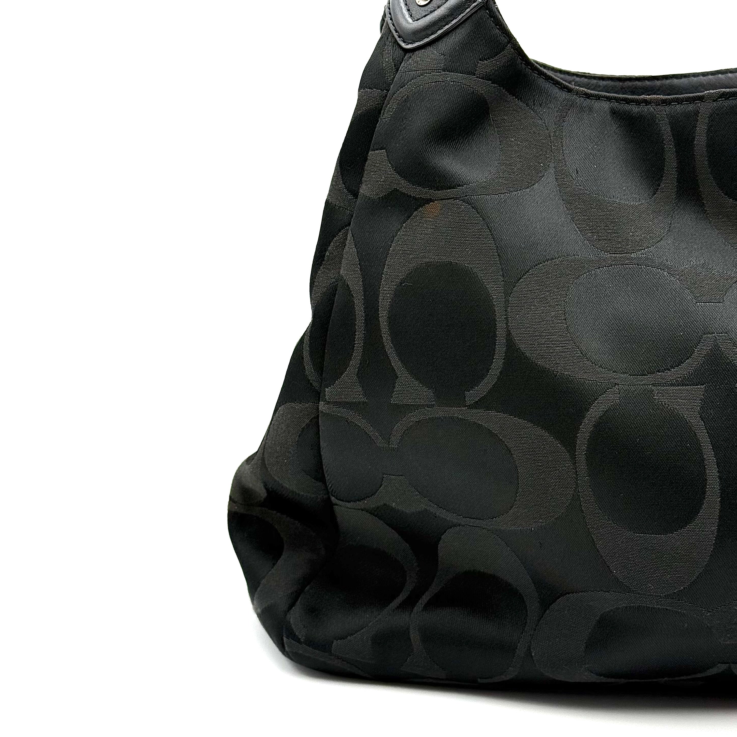 Coach Signature Campbell Hobo Shoulder Bag in black jacquard canvas with leather trim and front buckle pocket, photographed against a white background.