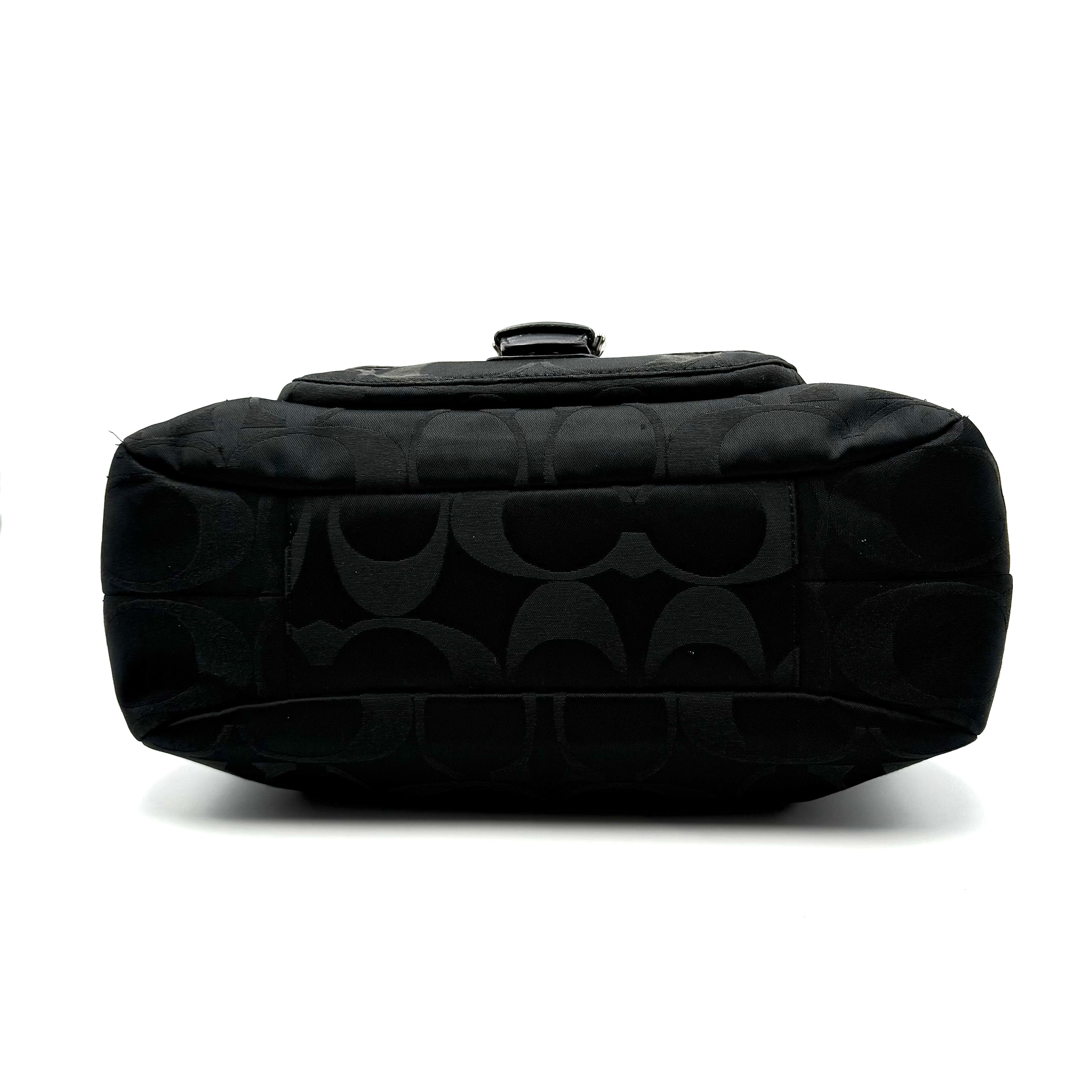 Coach Signature Campbell Hobo Shoulder Bag in black jacquard canvas with leather trim and front buckle pocket, photographed against a white background.