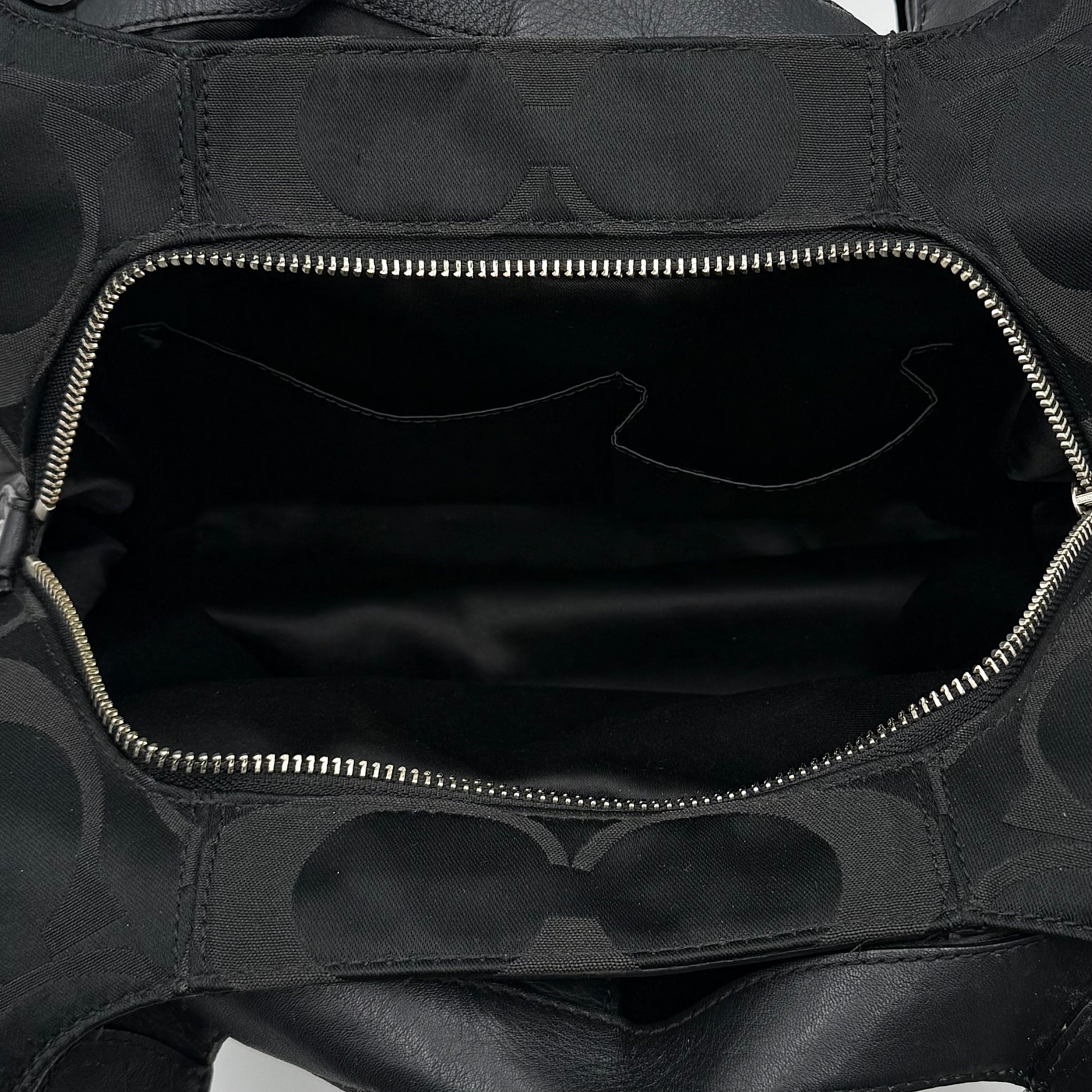 Coach Signature Campbell Hobo Shoulder Bag in black jacquard canvas with leather trim and front buckle pocket, photographed against a white background.