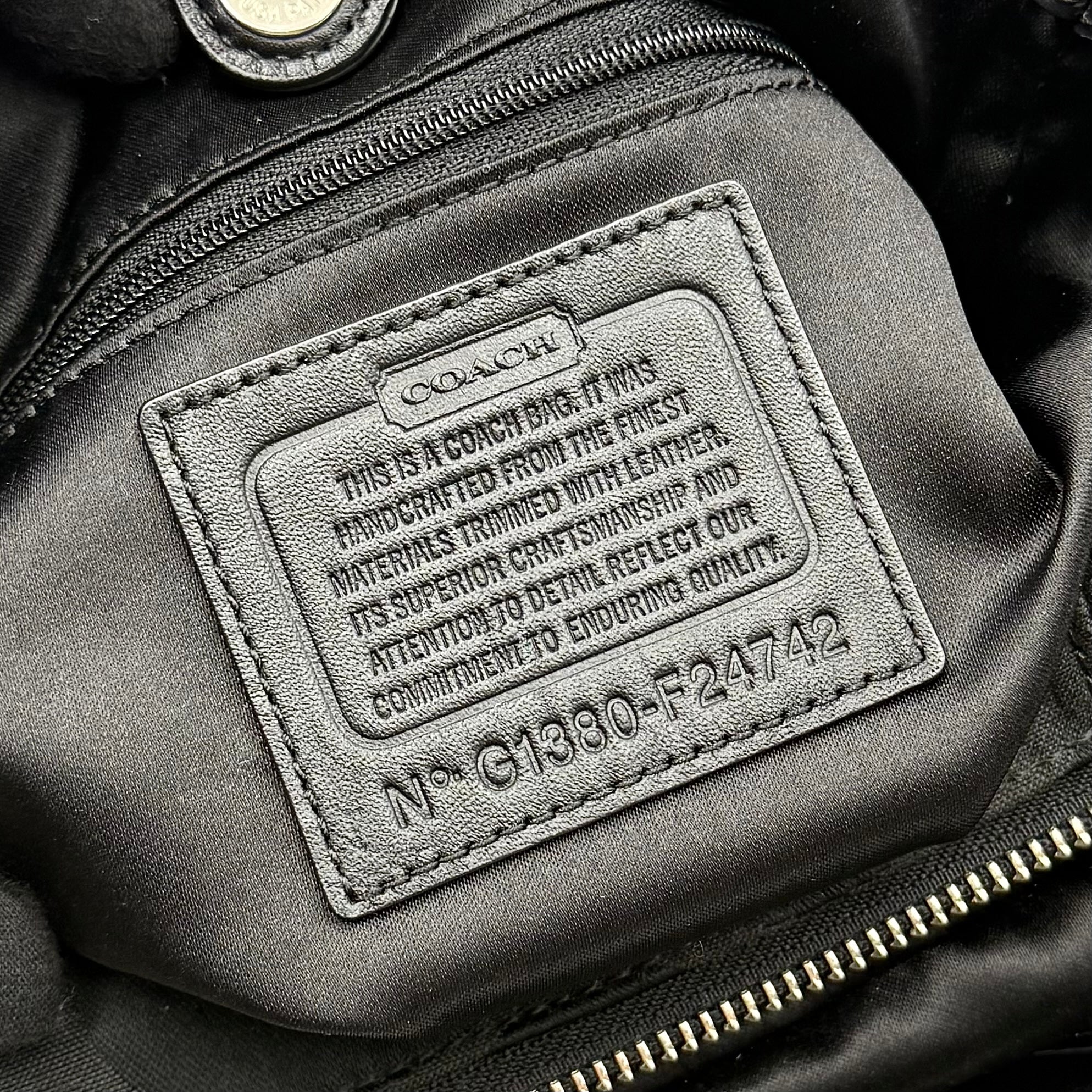 Coach Signature Campbell Hobo Shoulder Bag in black jacquard canvas with leather trim and front buckle pocket, photographed against a white background.