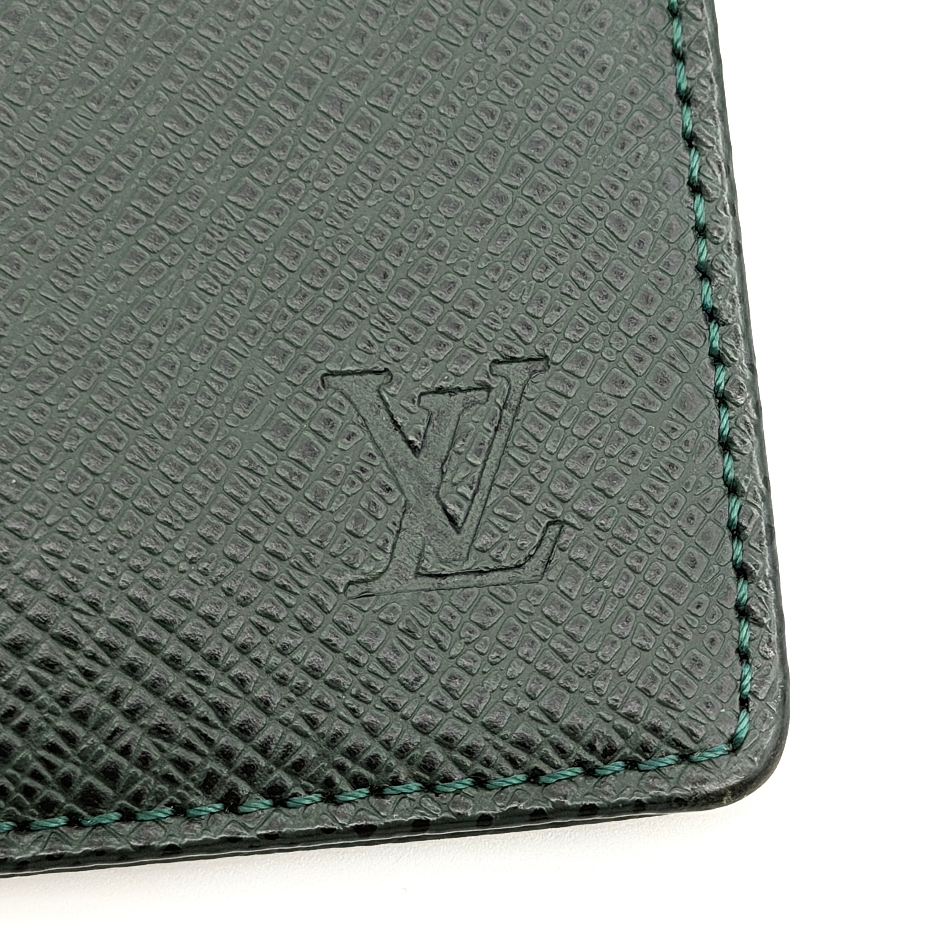 Louis Vuitton dark green Taiga leather card case with subtle LV monogram, box, dust bag, and care card.