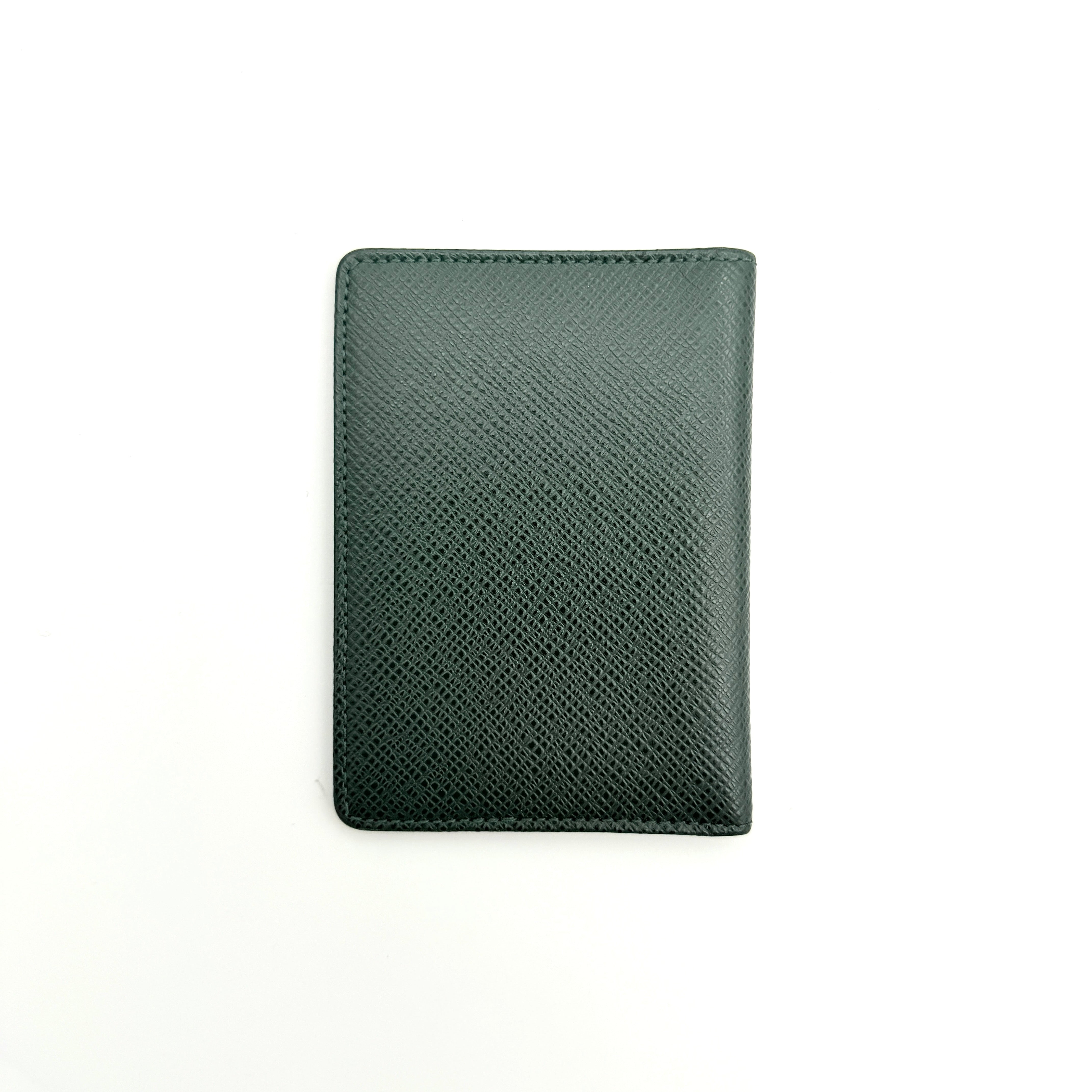 Louis Vuitton dark green Taiga leather card case with subtle LV monogram, box, dust bag, and care card.