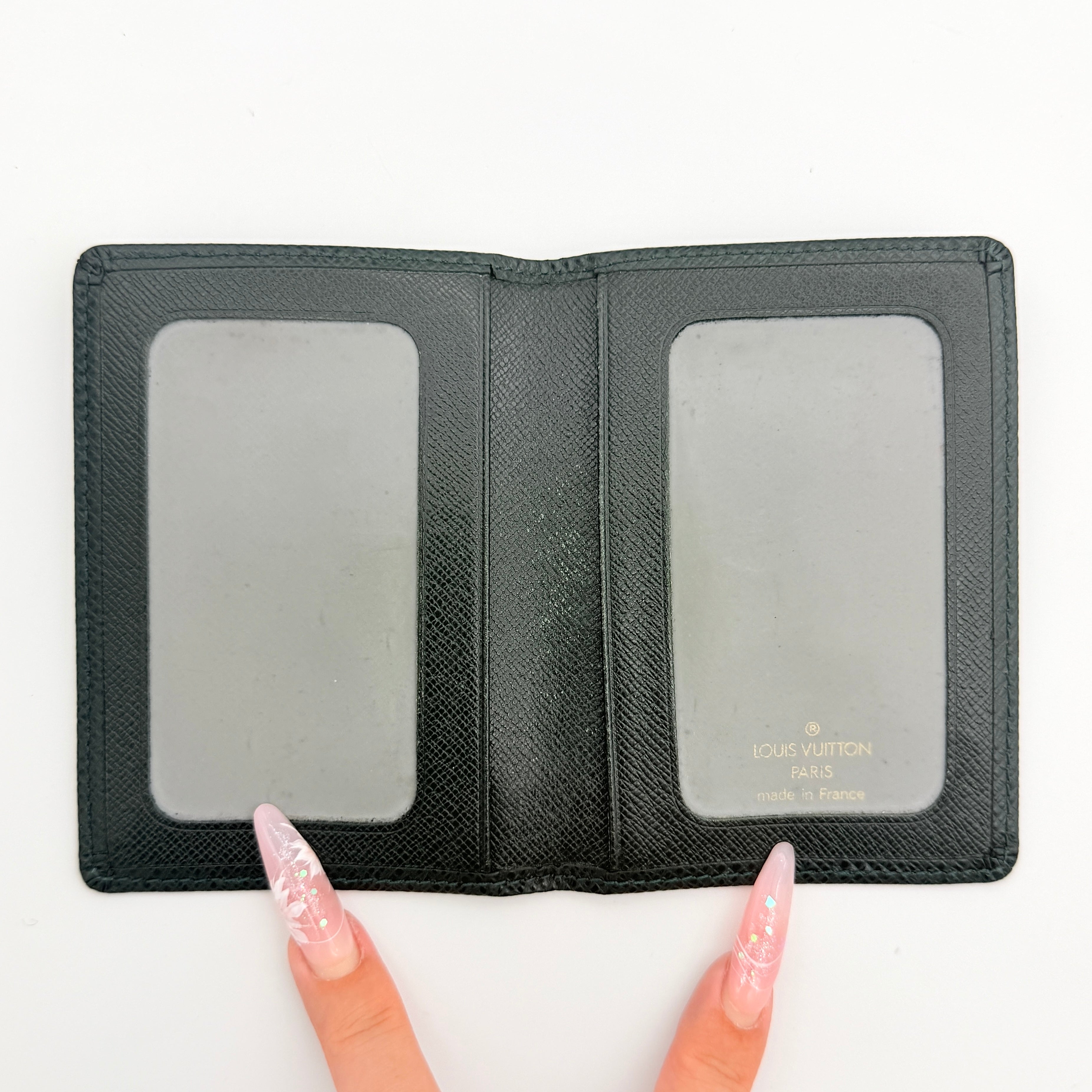 Louis Vuitton dark green Taiga leather card case with subtle LV monogram, box, dust bag, and care card.