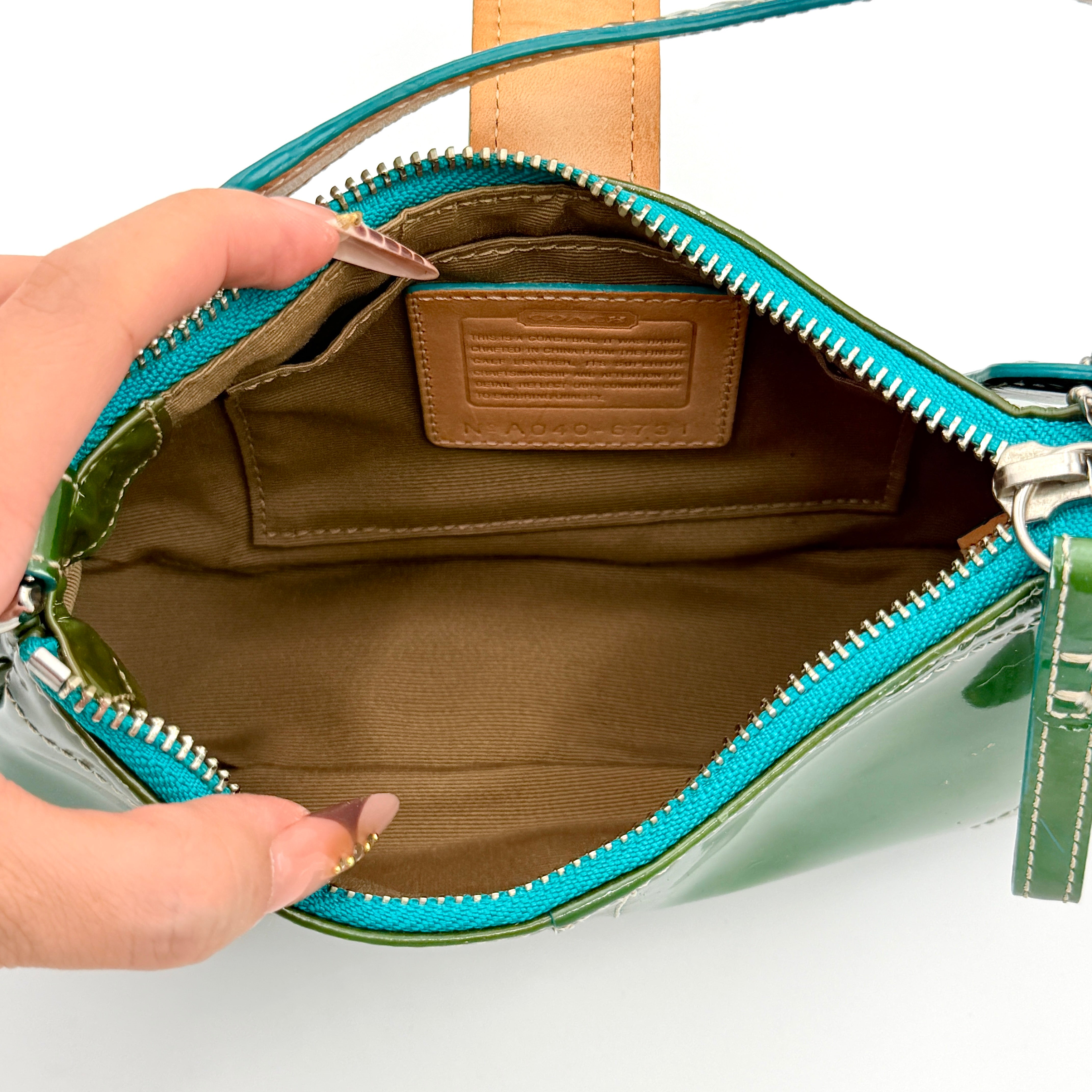 Coach Y2K Demi Soho shoulder bag in glossy green patent leather with silver hardware and natural leather strap.
