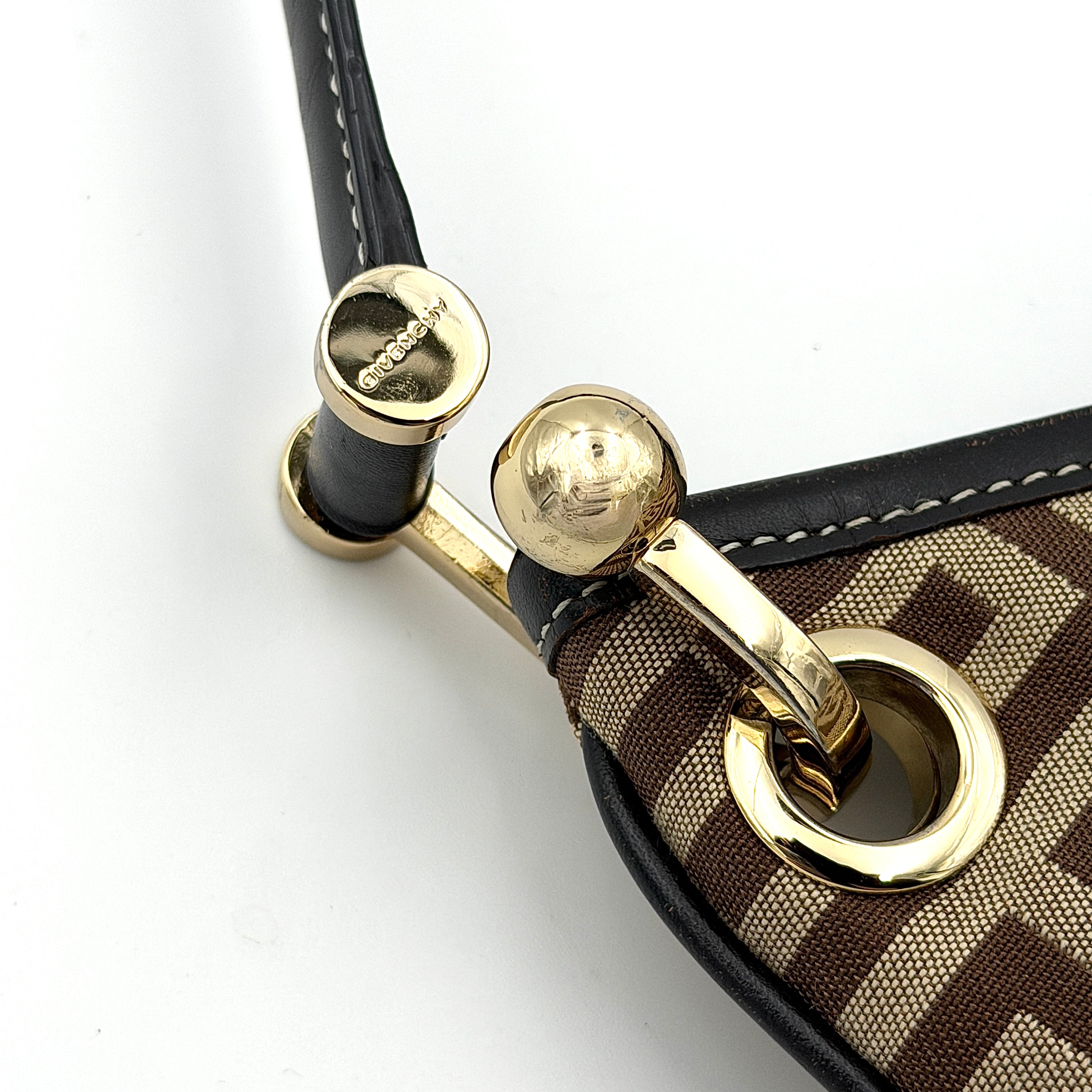The Givenchy Monogram Hobo Shoulder Bag in brown canvas with black leather trim and gold hardware, displayed front-facing.