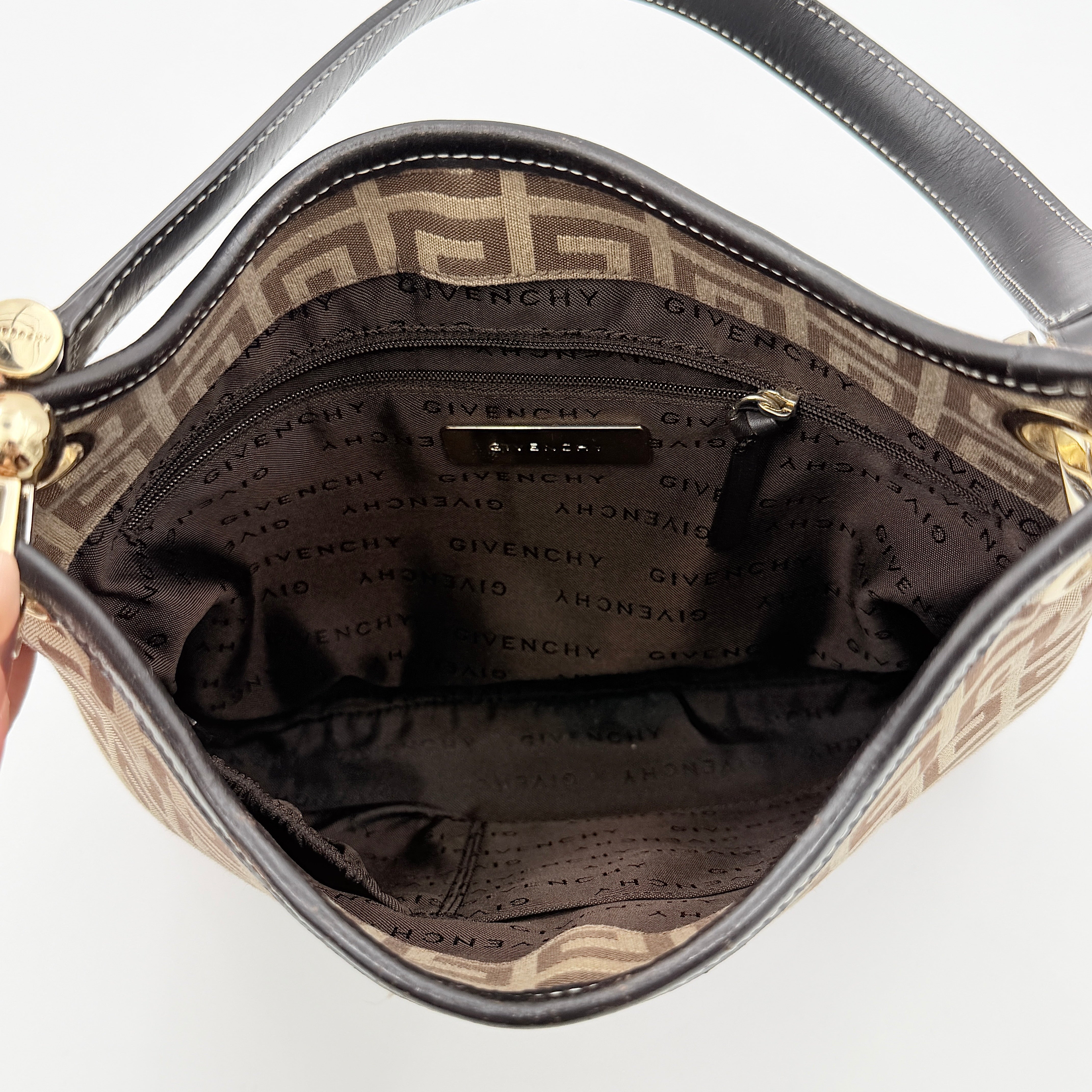 The Givenchy Monogram Hobo Shoulder Bag in brown canvas with black leather trim and gold hardware, displayed front-facing.