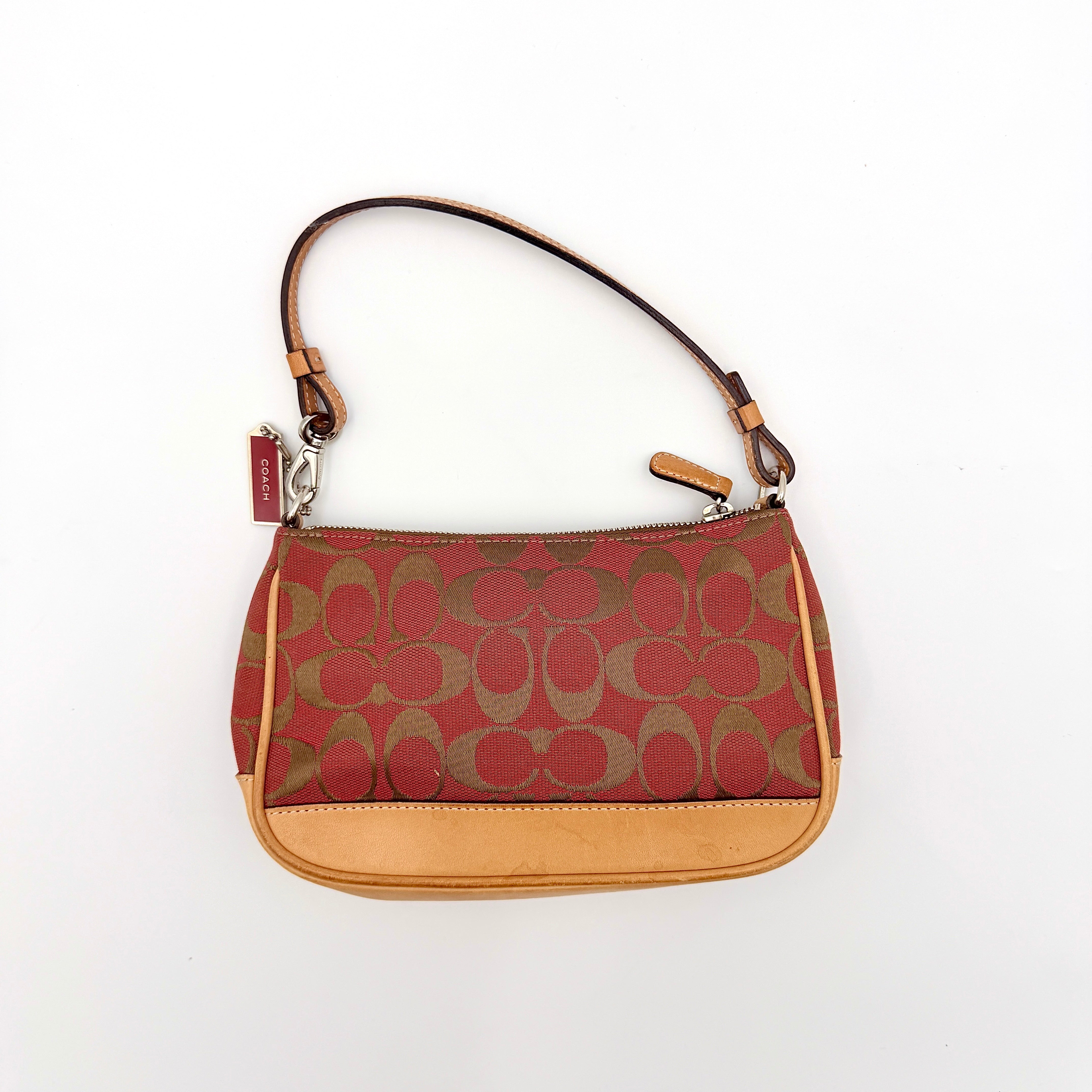 Coach Y2K Demi Shoulder Bag in red and tan signature monogram with leather trim, shown with leather strap and Coach tag.