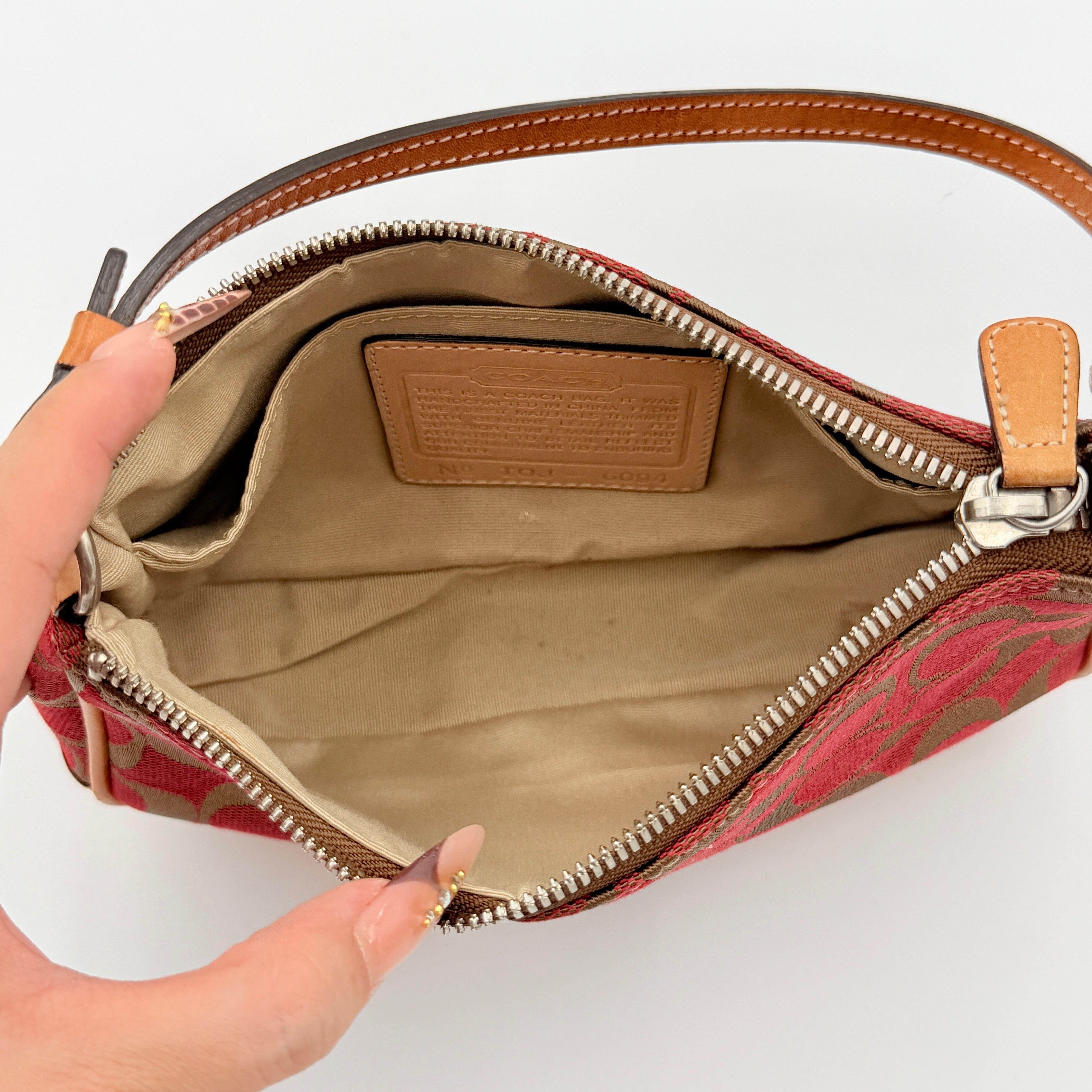 Coach Y2K Demi Shoulder Bag in red and tan signature monogram with leather trim, shown with leather strap and Coach tag.