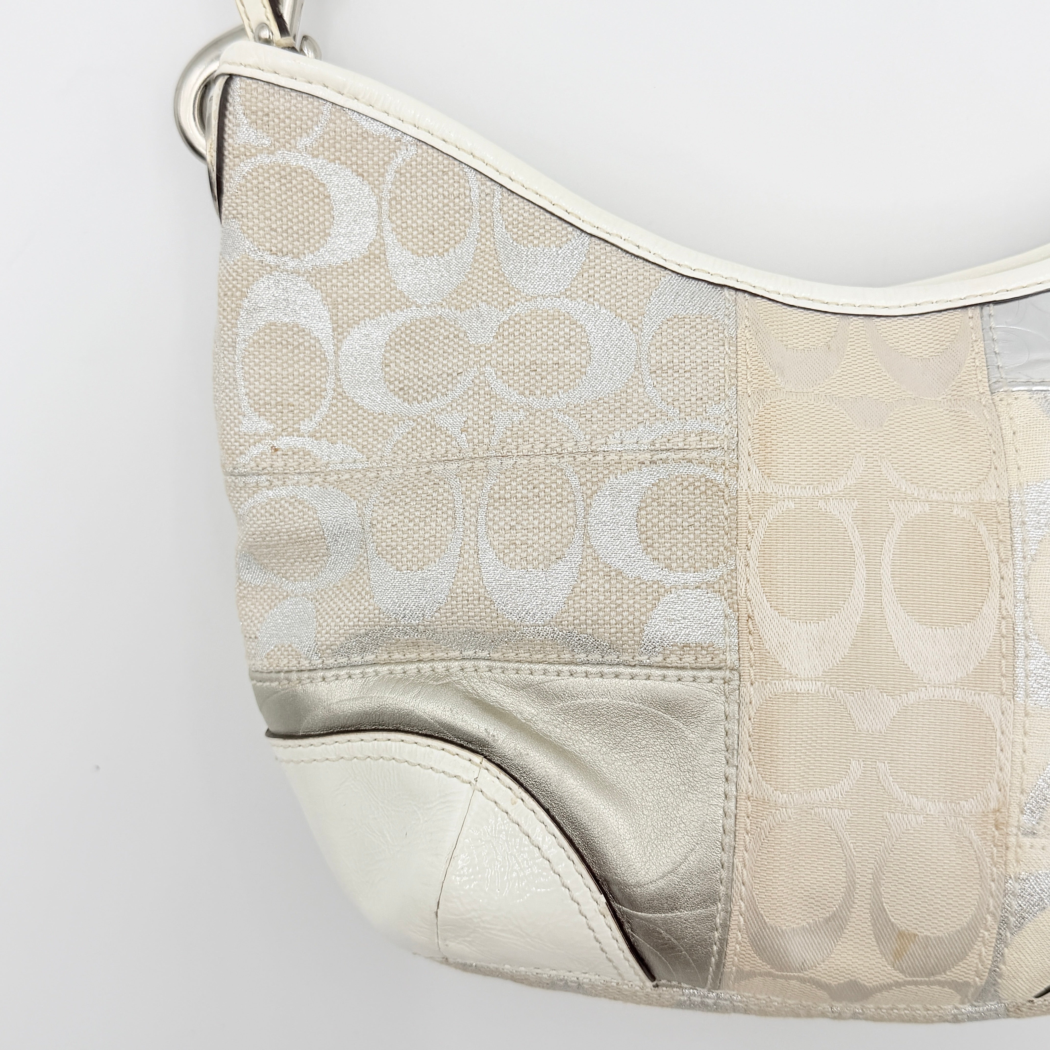 Coach Y2K Signature Patchwork Hobo Shoulder Bag in cream and silver jacquard with wide leather handle, shown on a white background.