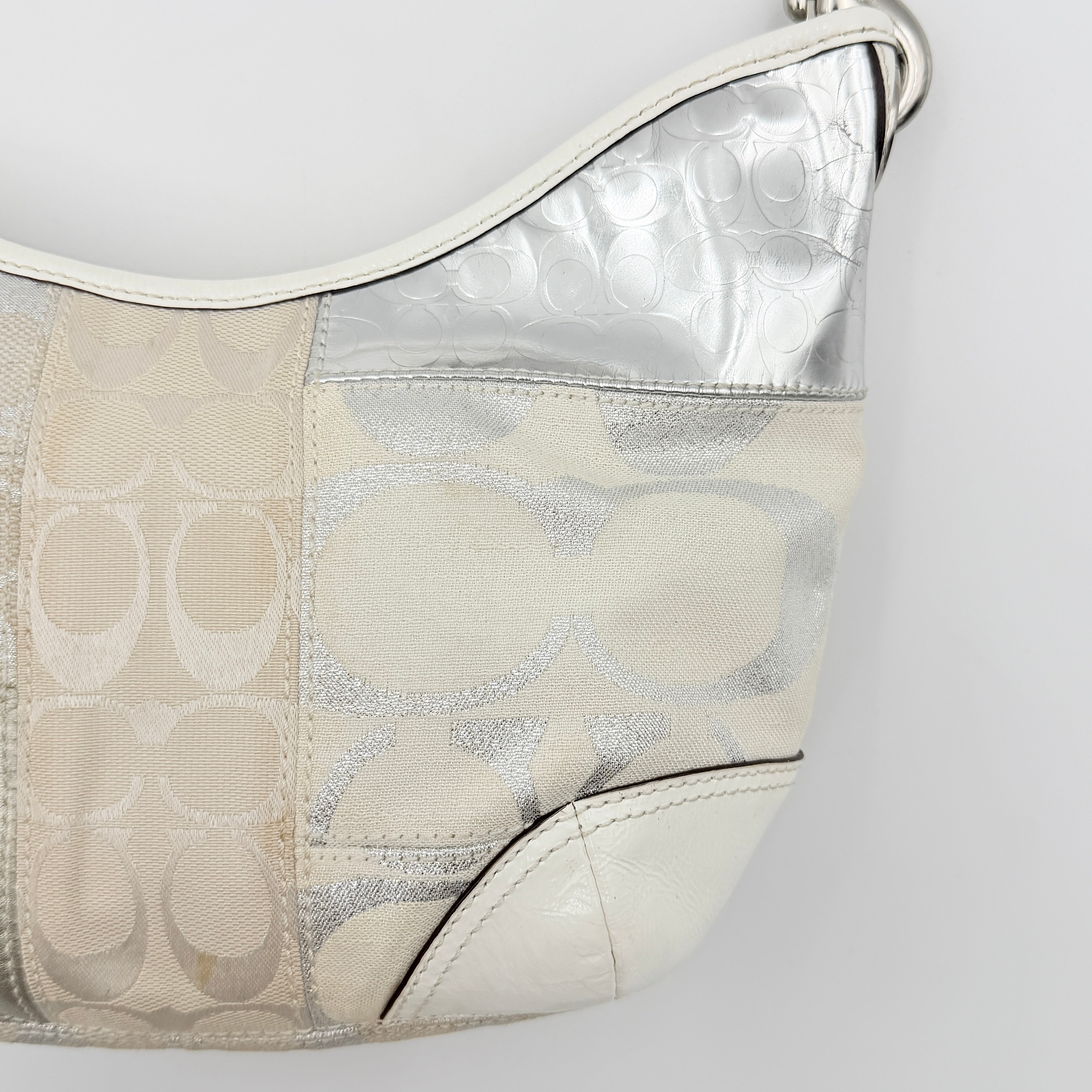 Coach Y2K Signature Patchwork Hobo Shoulder Bag in cream and silver jacquard with wide leather handle, shown on a white background.