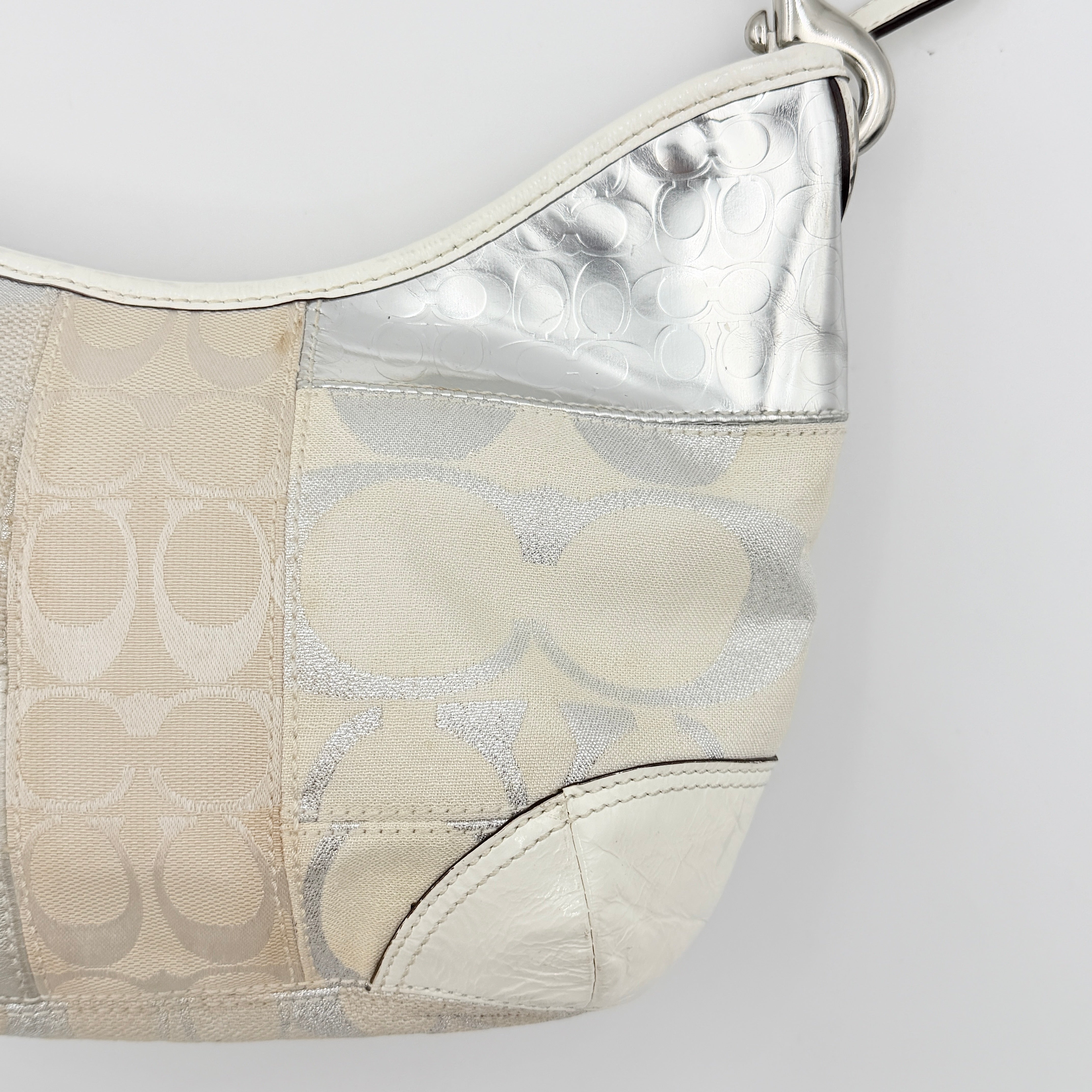 Coach Y2K Signature Patchwork Hobo Shoulder Bag in cream and silver jacquard with wide leather handle, shown on a white background.