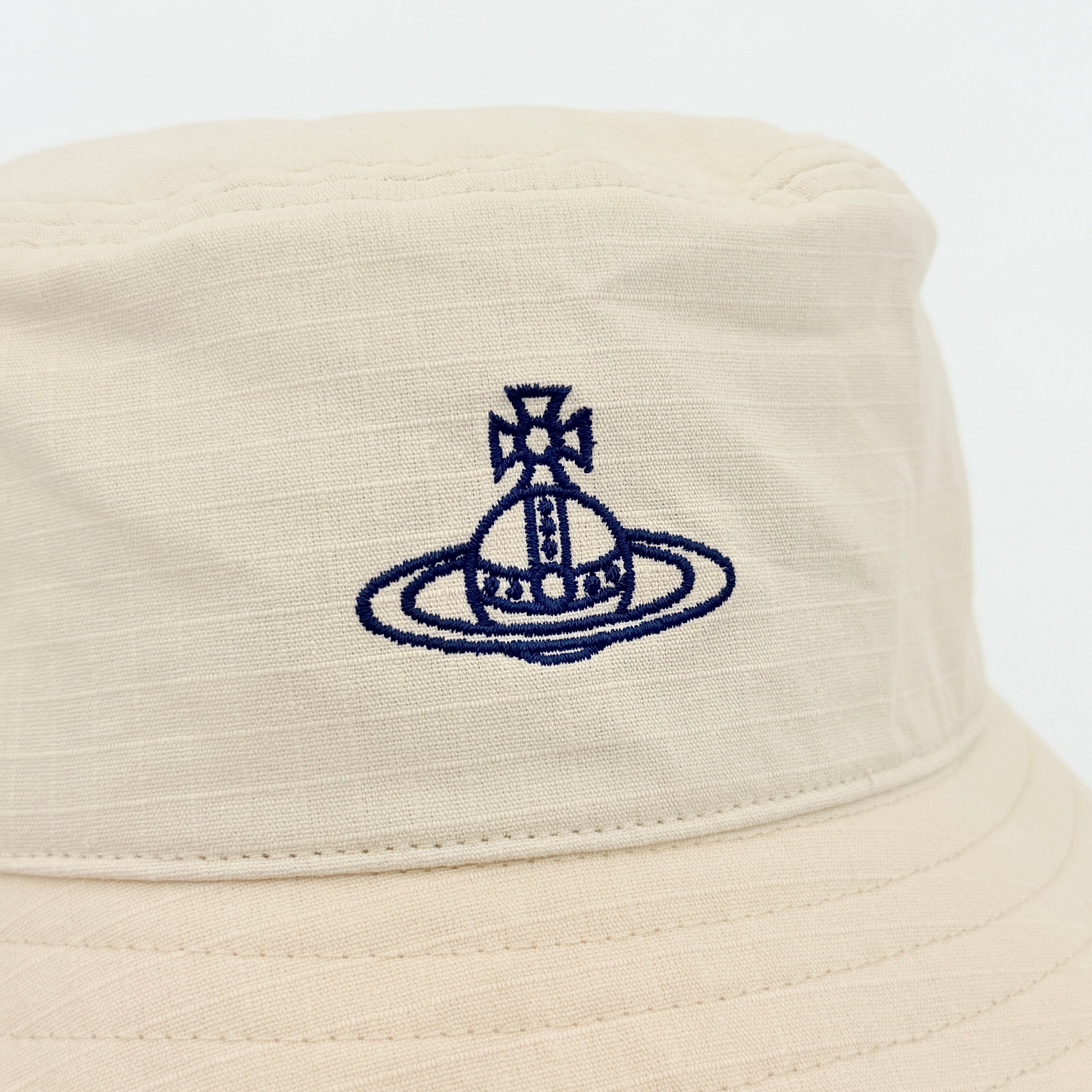 Vivienne Westwood Orb London bucket hat in cream cotton with black embroidery, shown from the front.