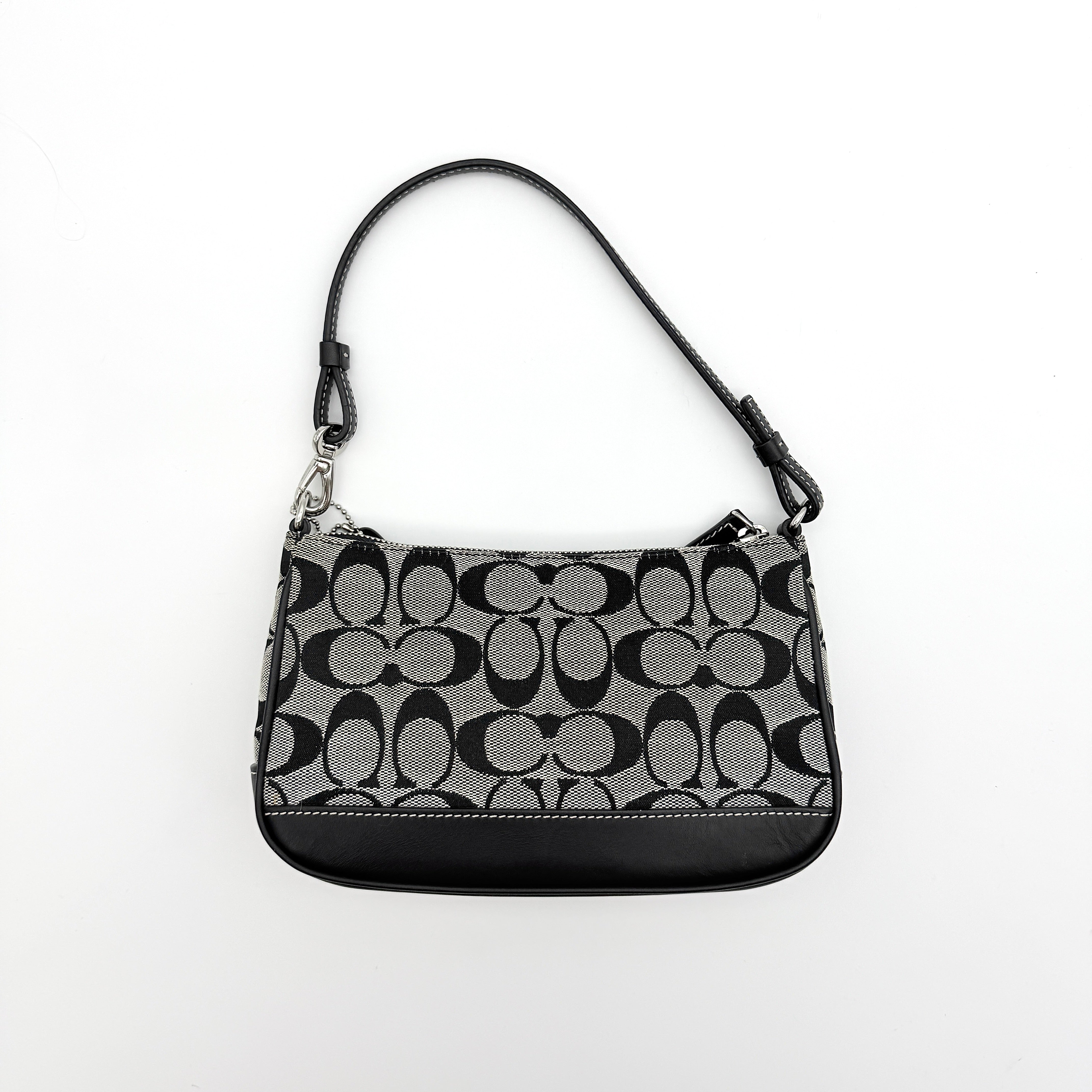 Coach Y2K demi shoulder bag in grey and black signature jacquard with black leather trim and silver hardware, shown with top handle and branded tag.