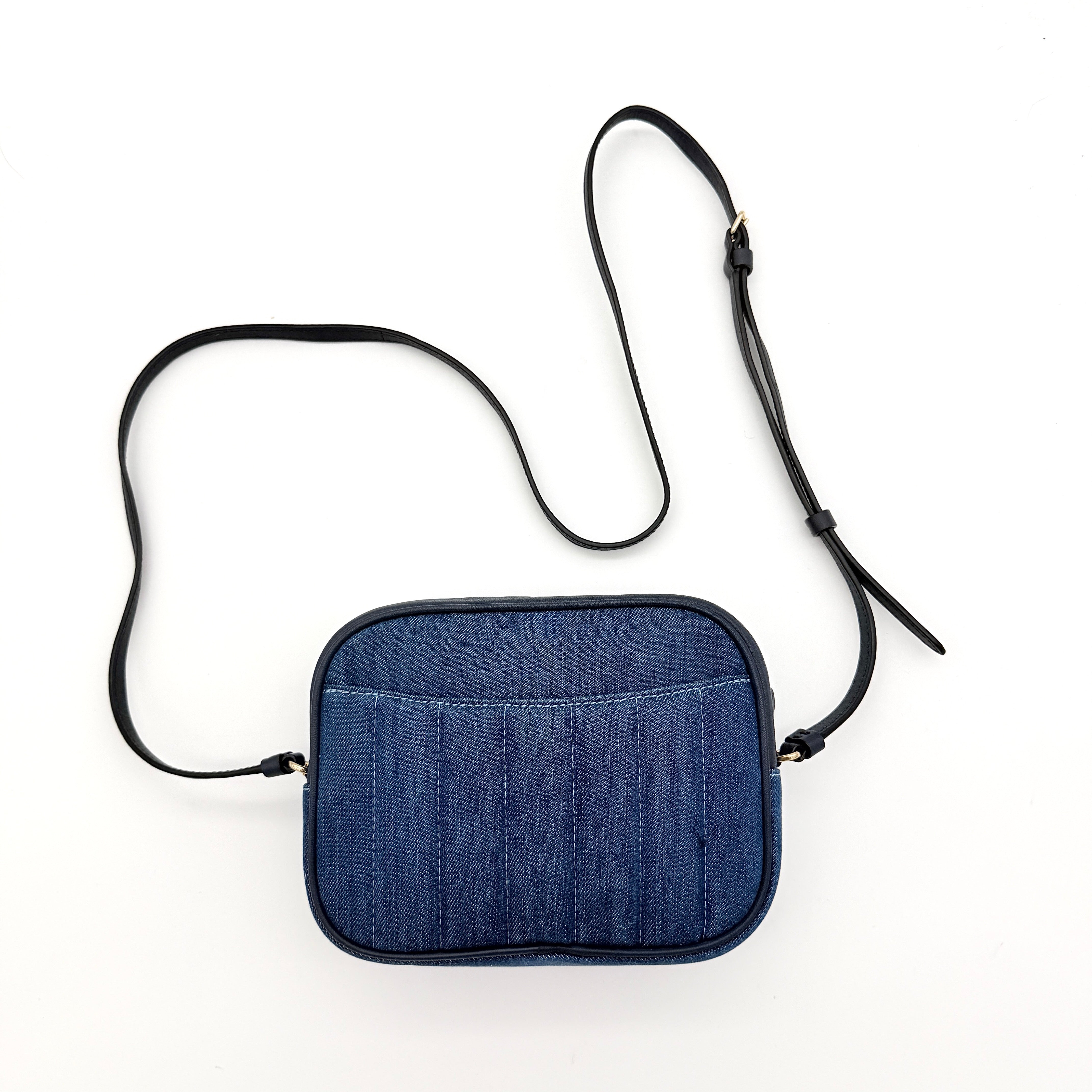 Coach Jamie Mini Camera Bag in quilted blue denim with navy leather trim and gold hardware, shown with its adjustable crossbody strap.