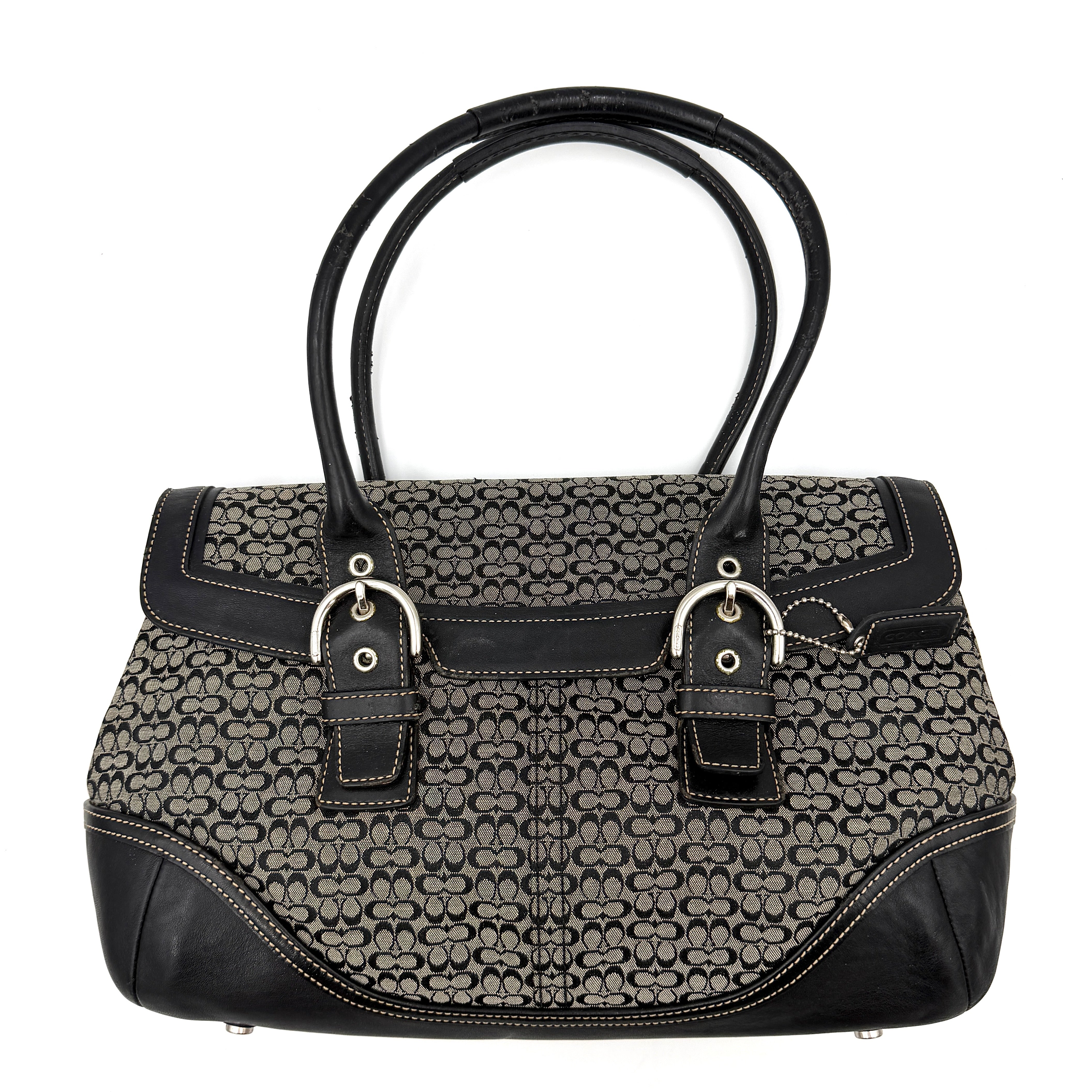 Coach Soho Hampton satchel in grey and black signature jacquard with black leather trim and silver-tone buckle details, presented upright with dual rolled handles.