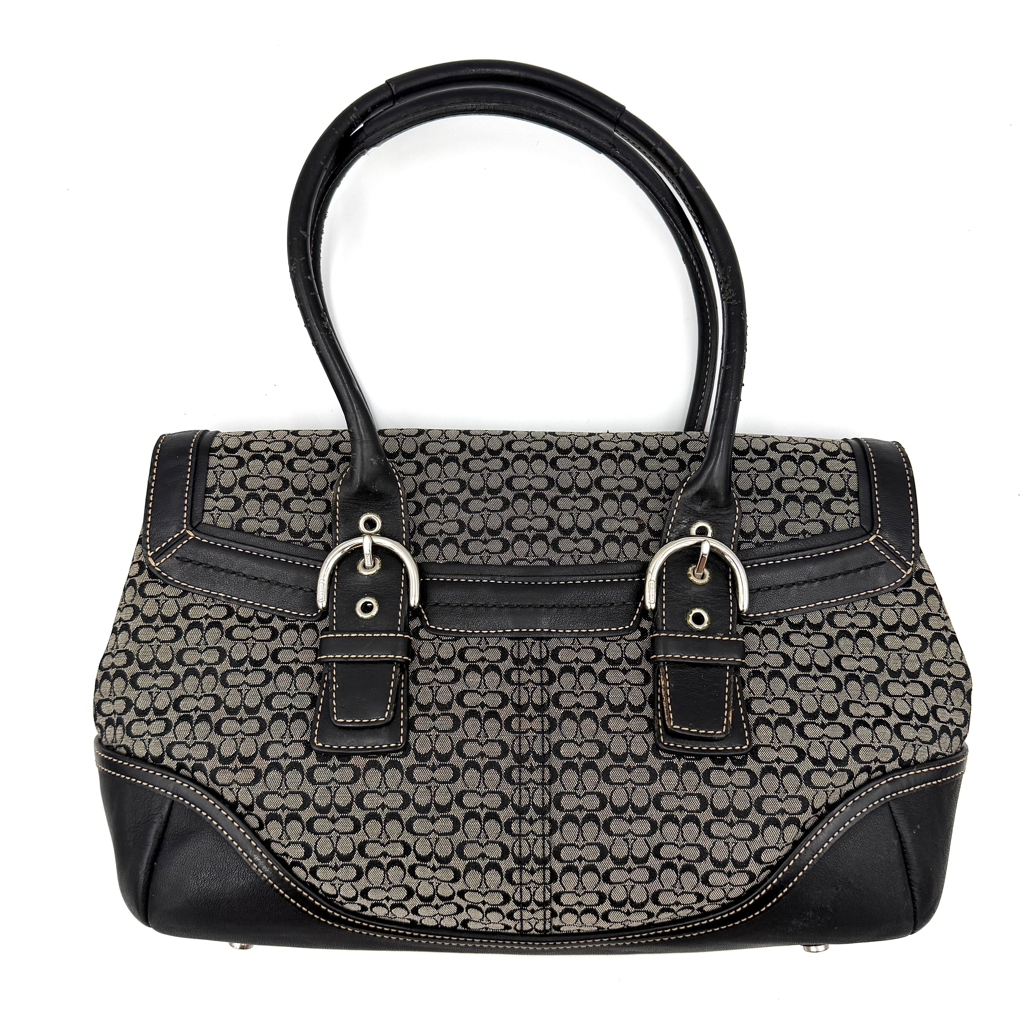 Coach Soho Hampton satchel in grey and black signature jacquard with black leather trim and silver-tone buckle details, presented upright with dual rolled handles.