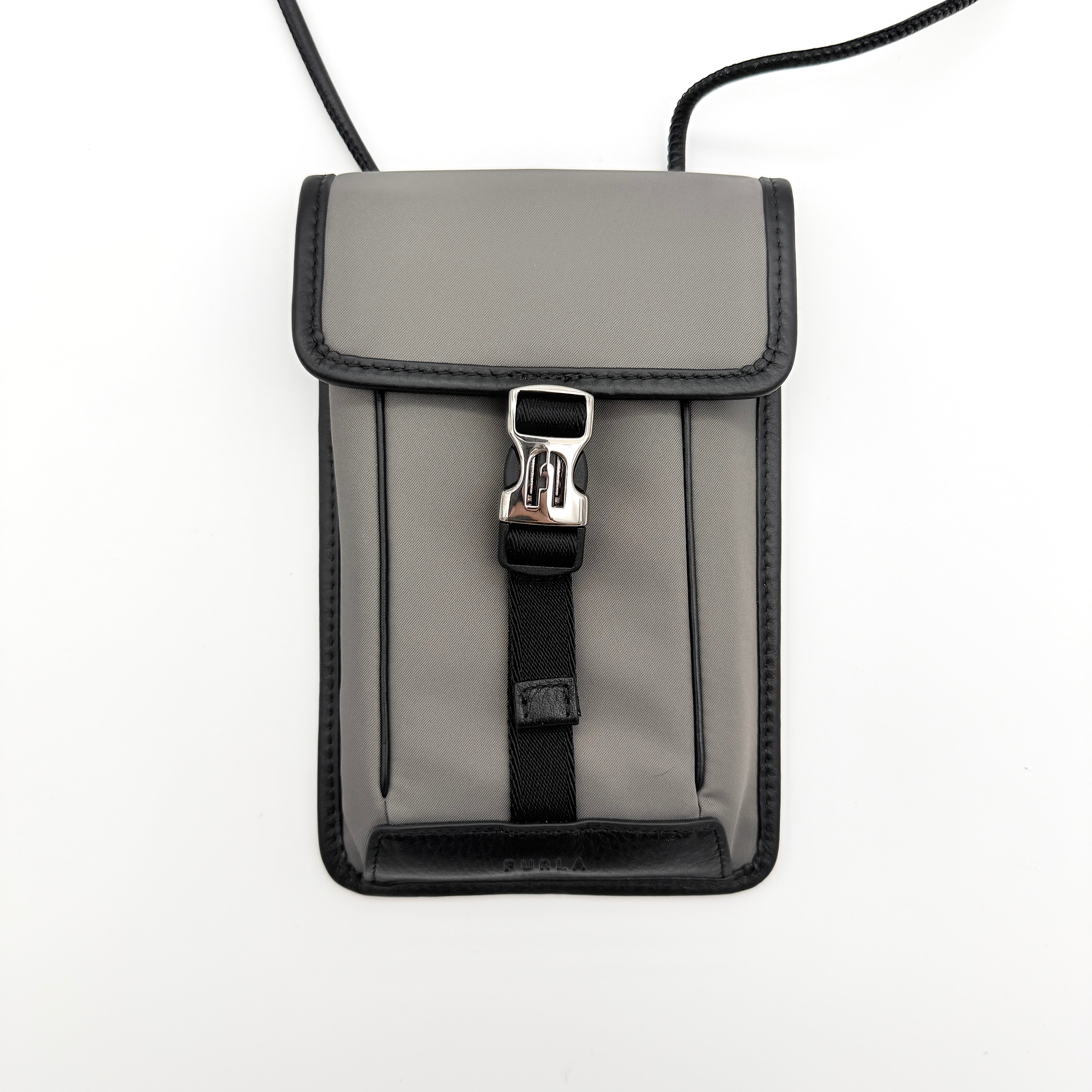 Furla Cosmo grey phone holder with black trim, silver buckle, and black cord strap on white background.