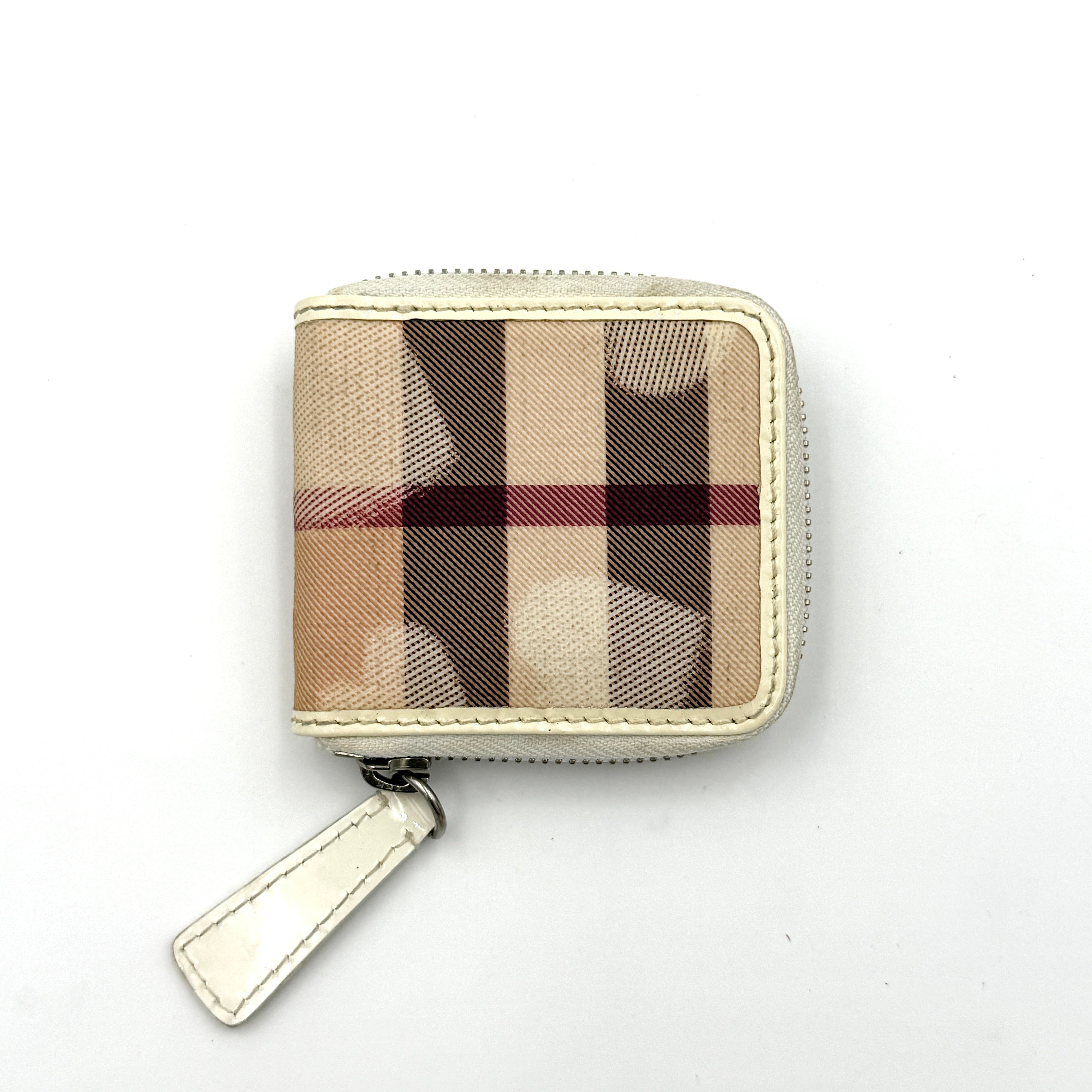 Burberry Heart Nova Check coin case in beige canvas with ivory leather trim and heart charms on the zipper pull.
