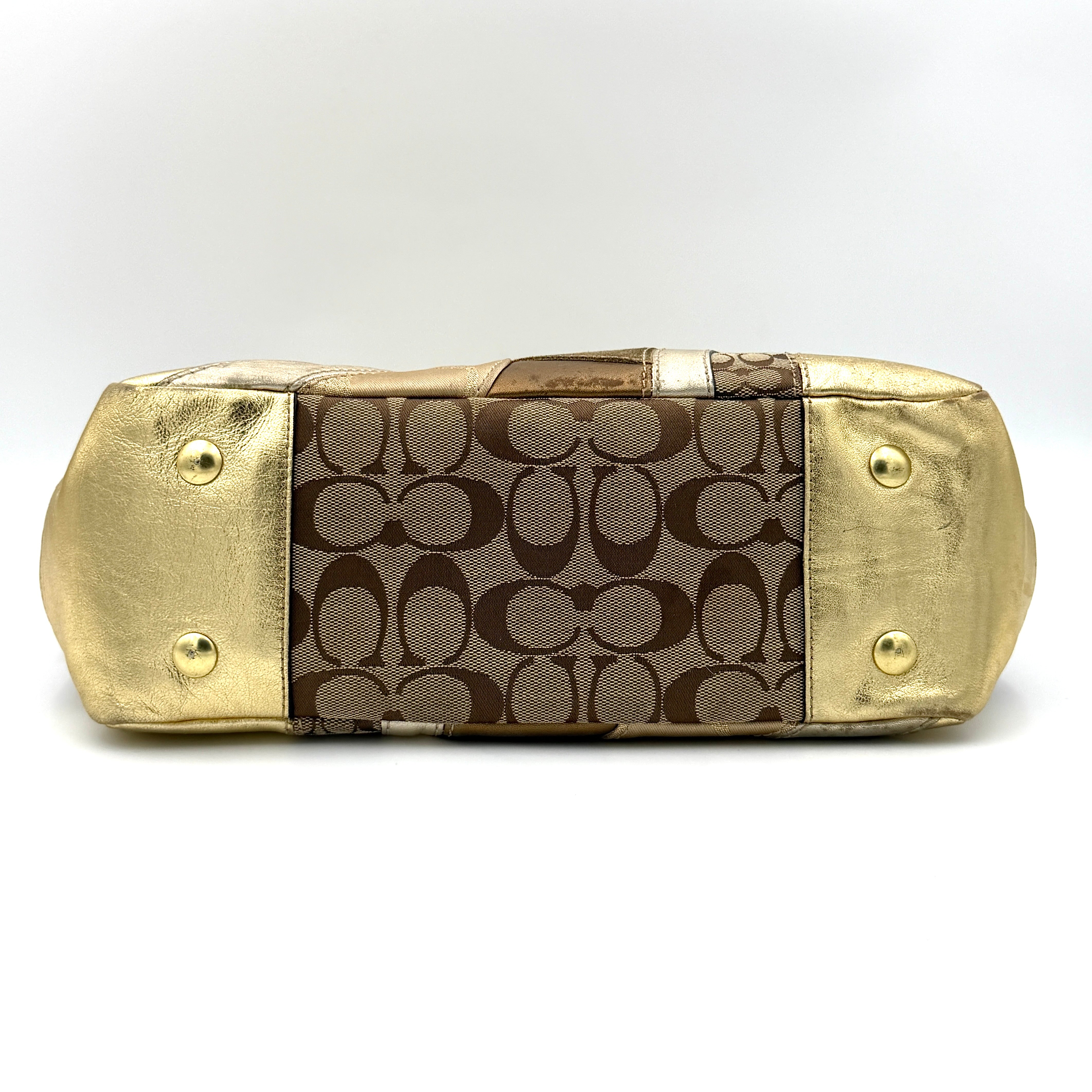 Coach Gallery Tote in a geometric patchwork of gold, beige, and tan with signature monogram and metallic leather against a white background.
