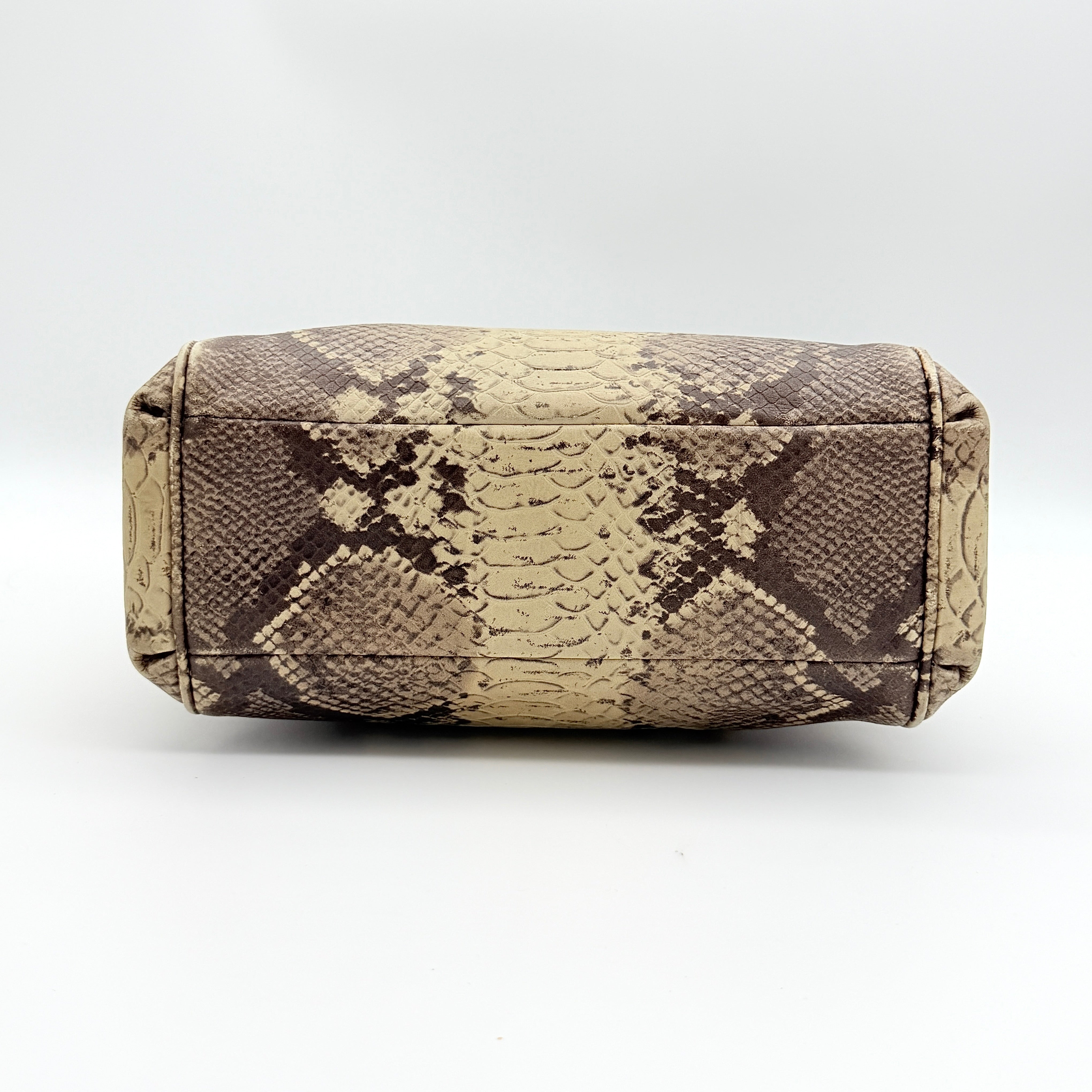Coach Minetta shoulder bag in python-embossed beige and brown leather with black handles and gold-tone hardware.
