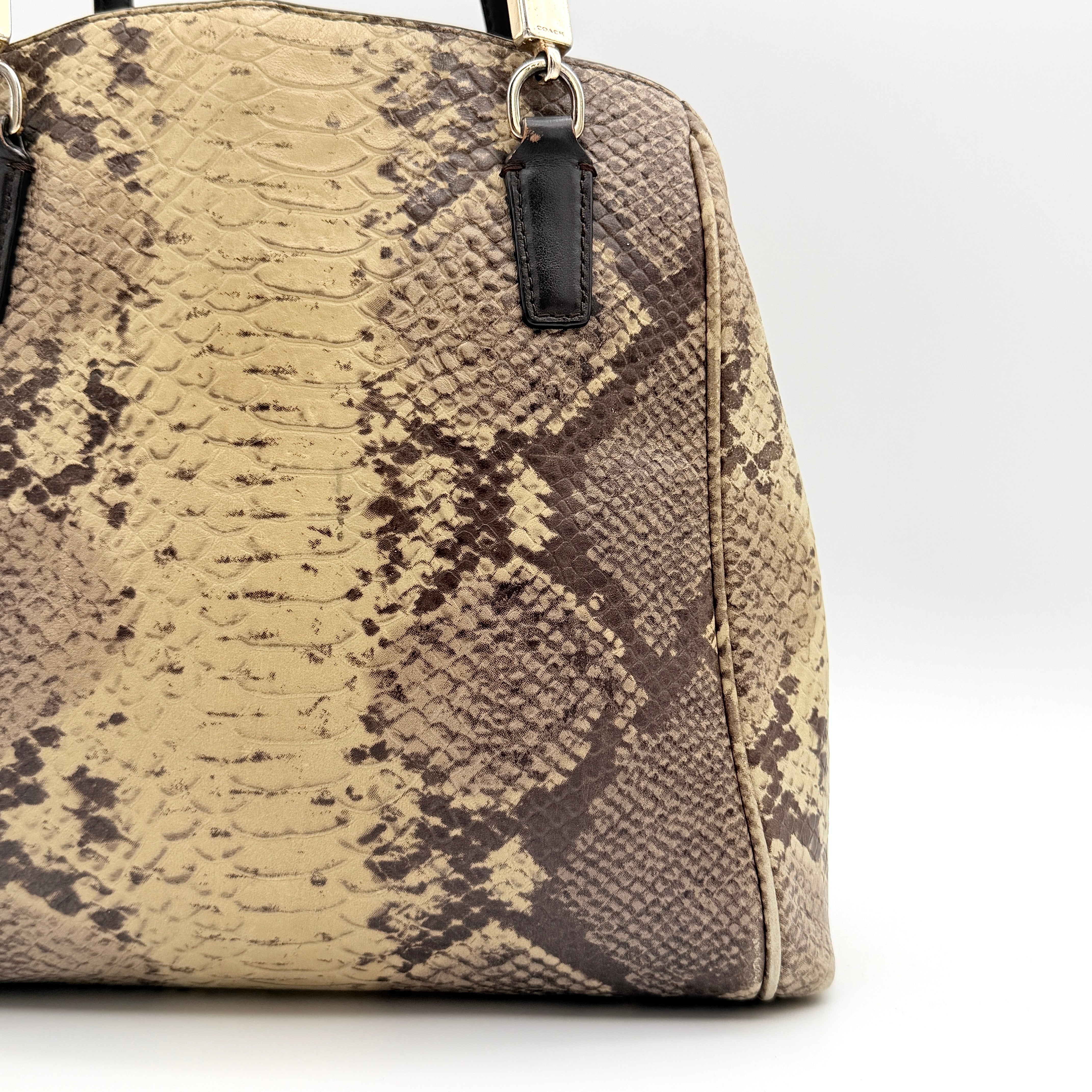 Coach Minetta shoulder bag in python-embossed beige and brown leather with black handles and gold-tone hardware.