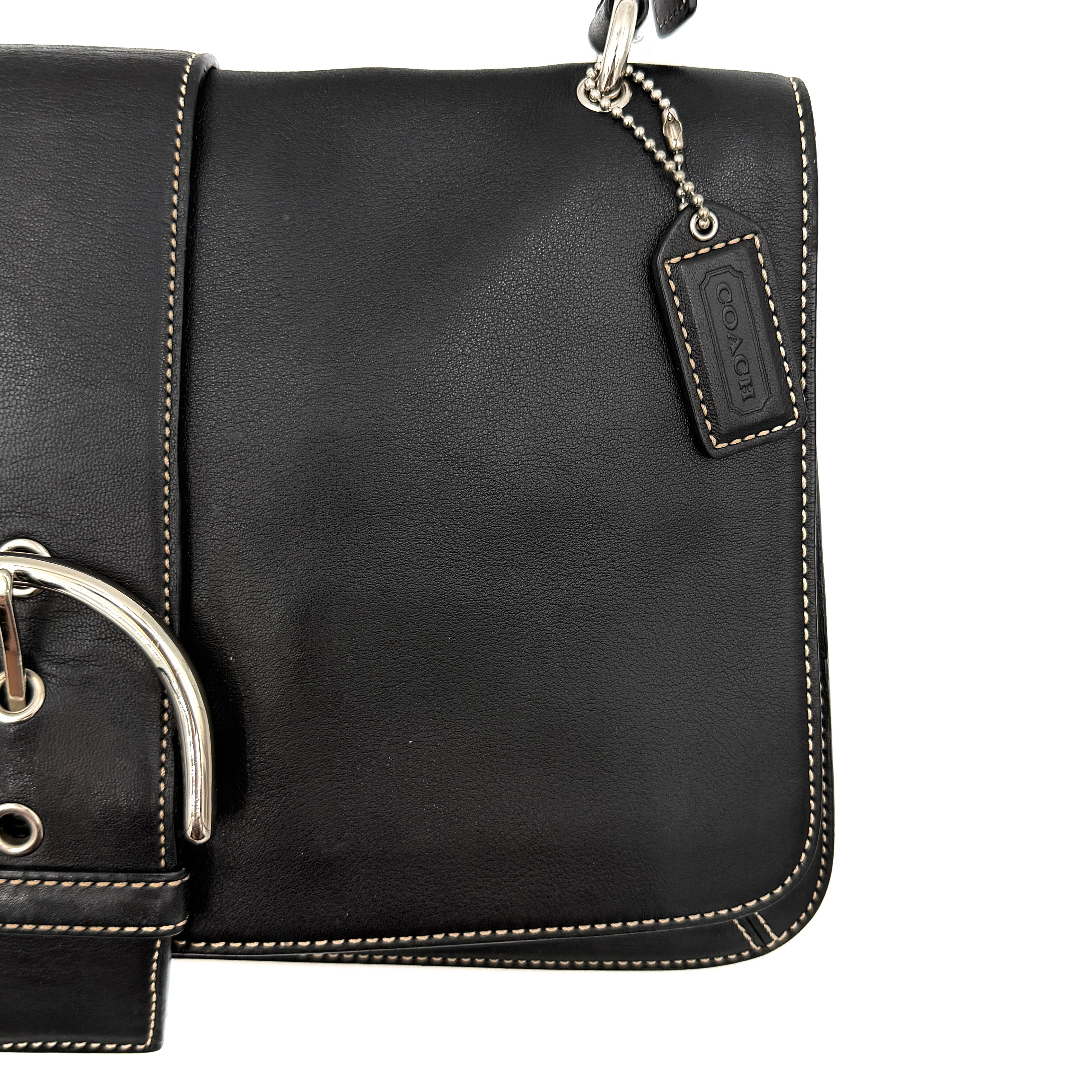 Coach Y2K Soho Buckle Shoulder Bag in smooth black leather with contrast stitching and a bold silver horseshoe buckle.