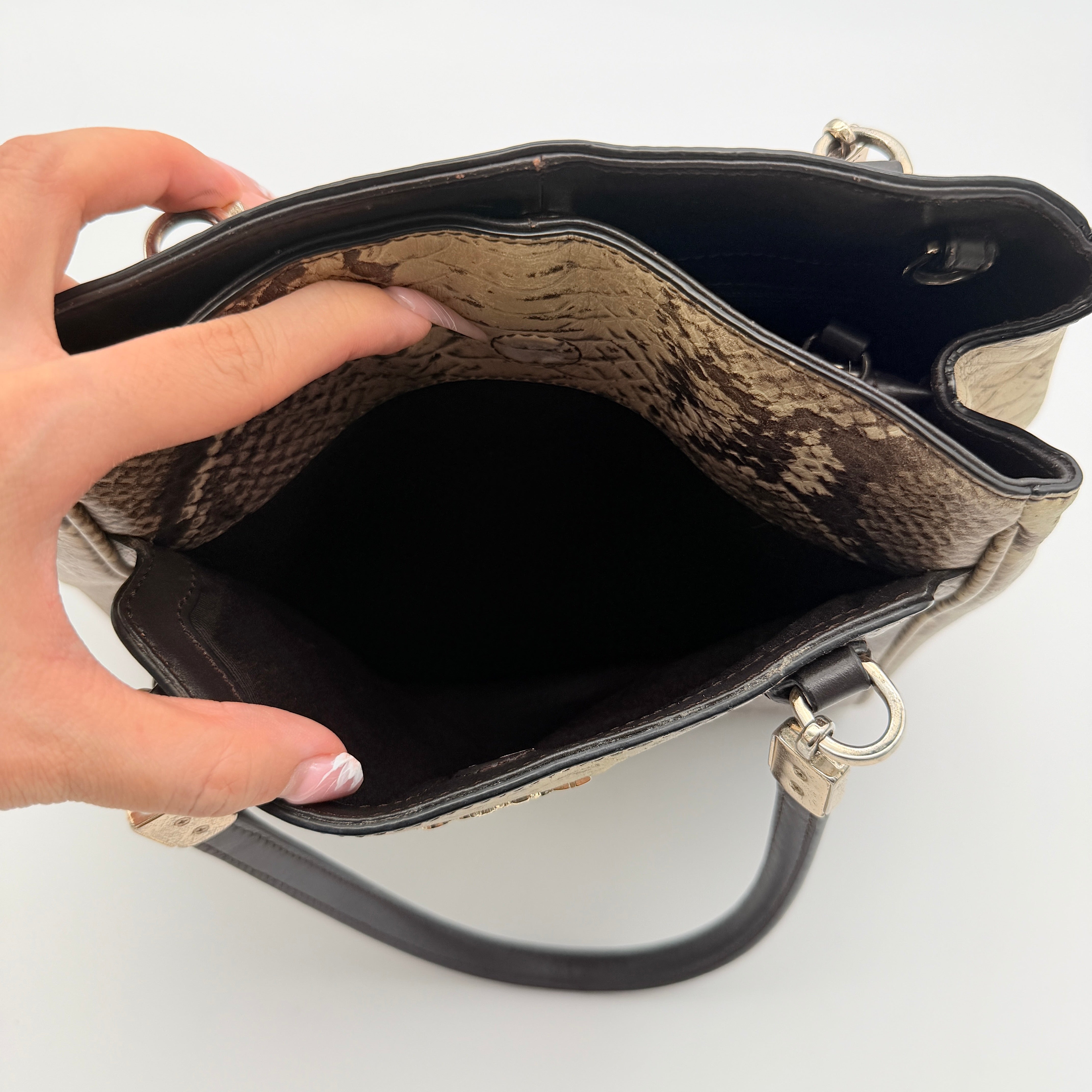Coach Minetta shoulder bag in python-embossed beige and brown leather with black handles and gold-tone hardware.