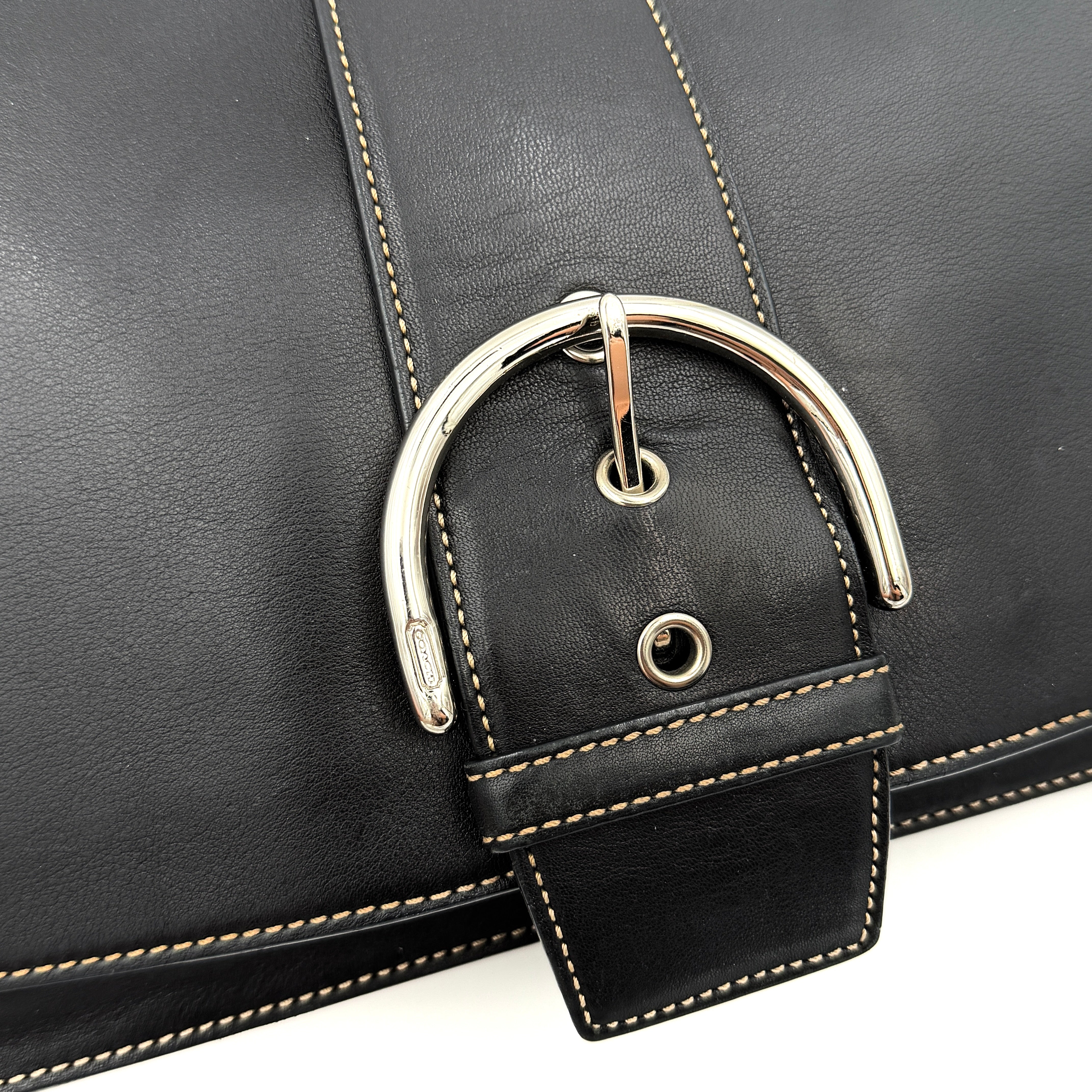 Coach Y2K Soho Buckle Shoulder Bag in smooth black leather with contrast stitching and a bold silver horseshoe buckle.