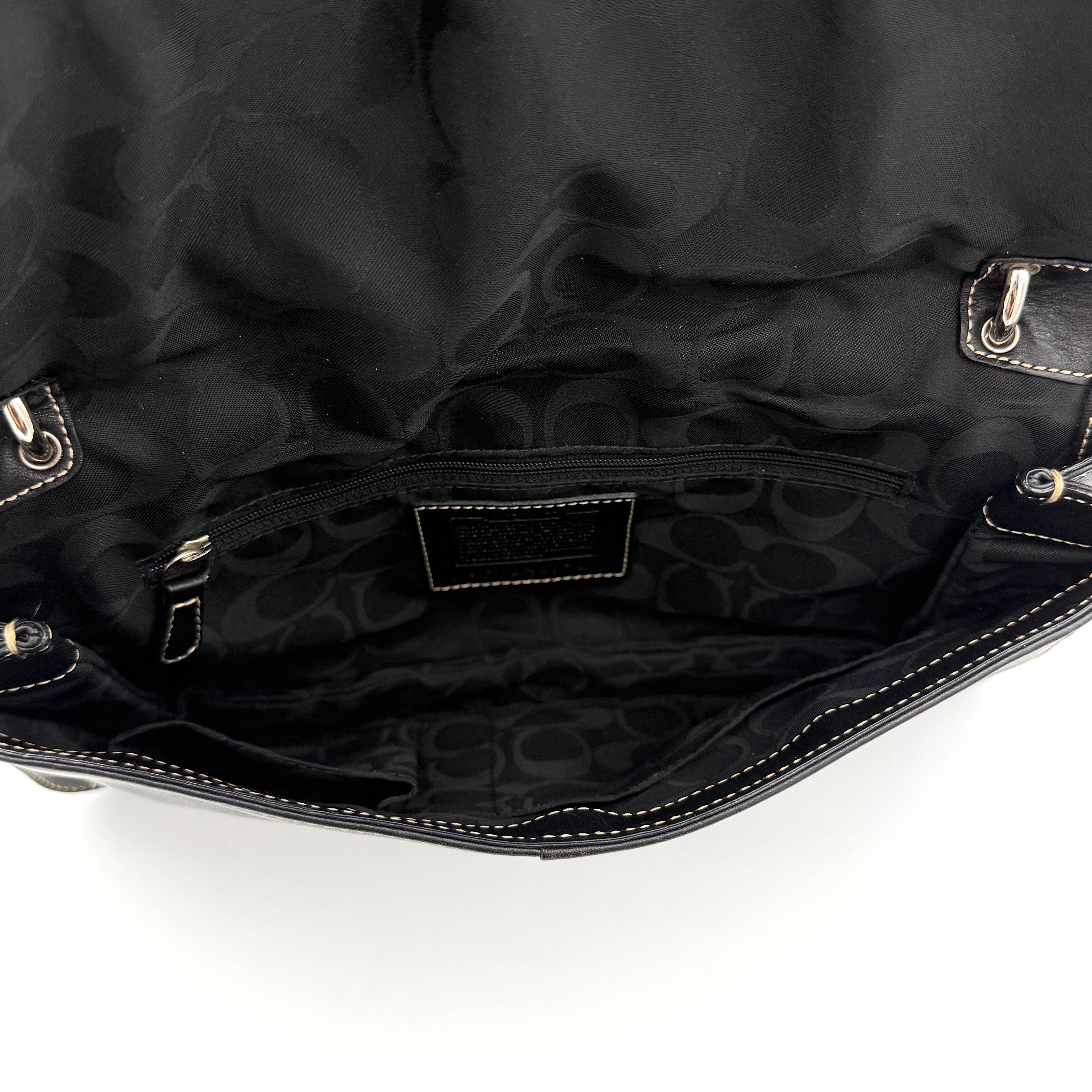 Coach Y2K Soho Buckle Shoulder Bag in smooth black leather with contrast stitching and a bold silver horseshoe buckle.