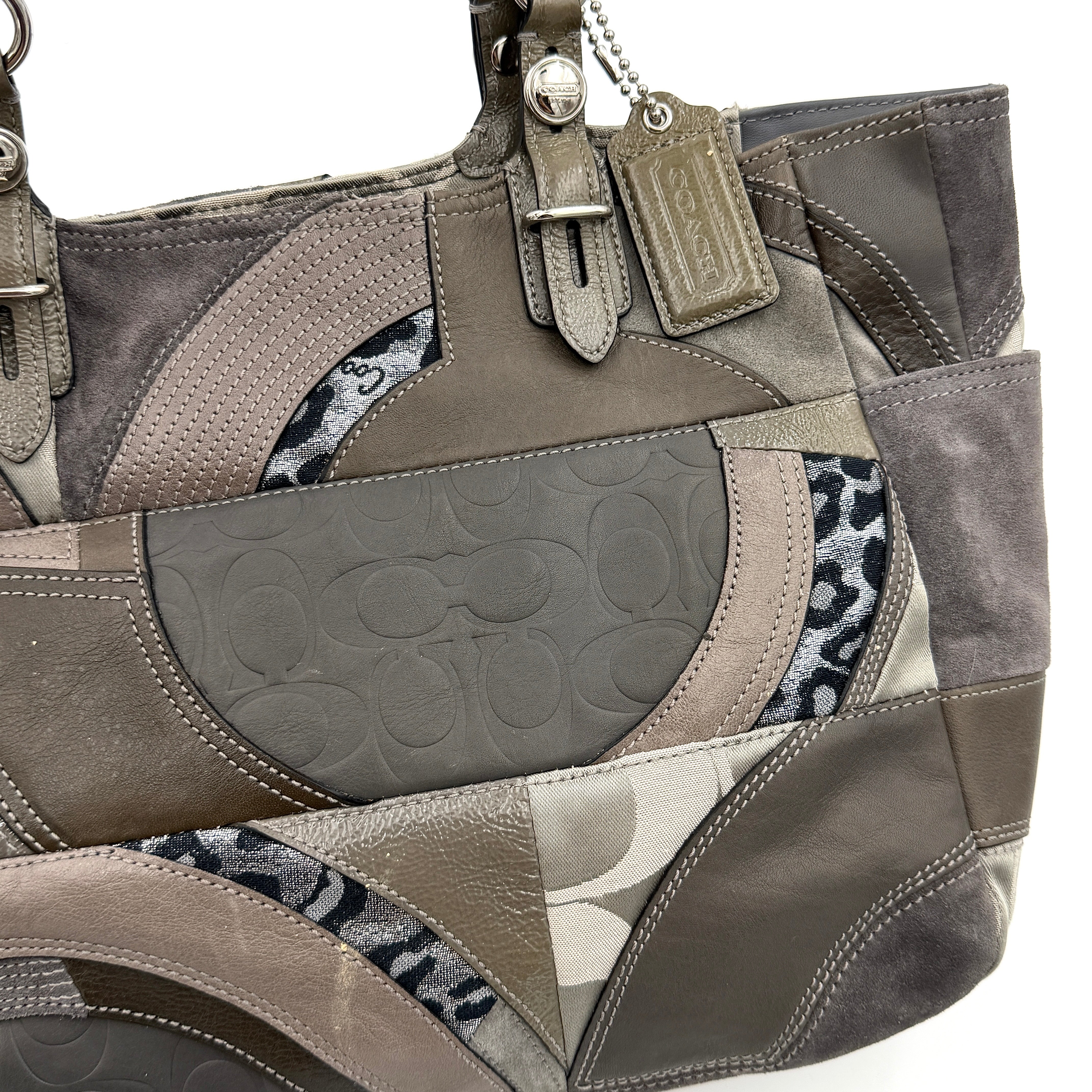 Coach Y2K patchwork tote in grey tones with jacquard, suede, and ocelot-print panels, shown with double handles and signature tag.
