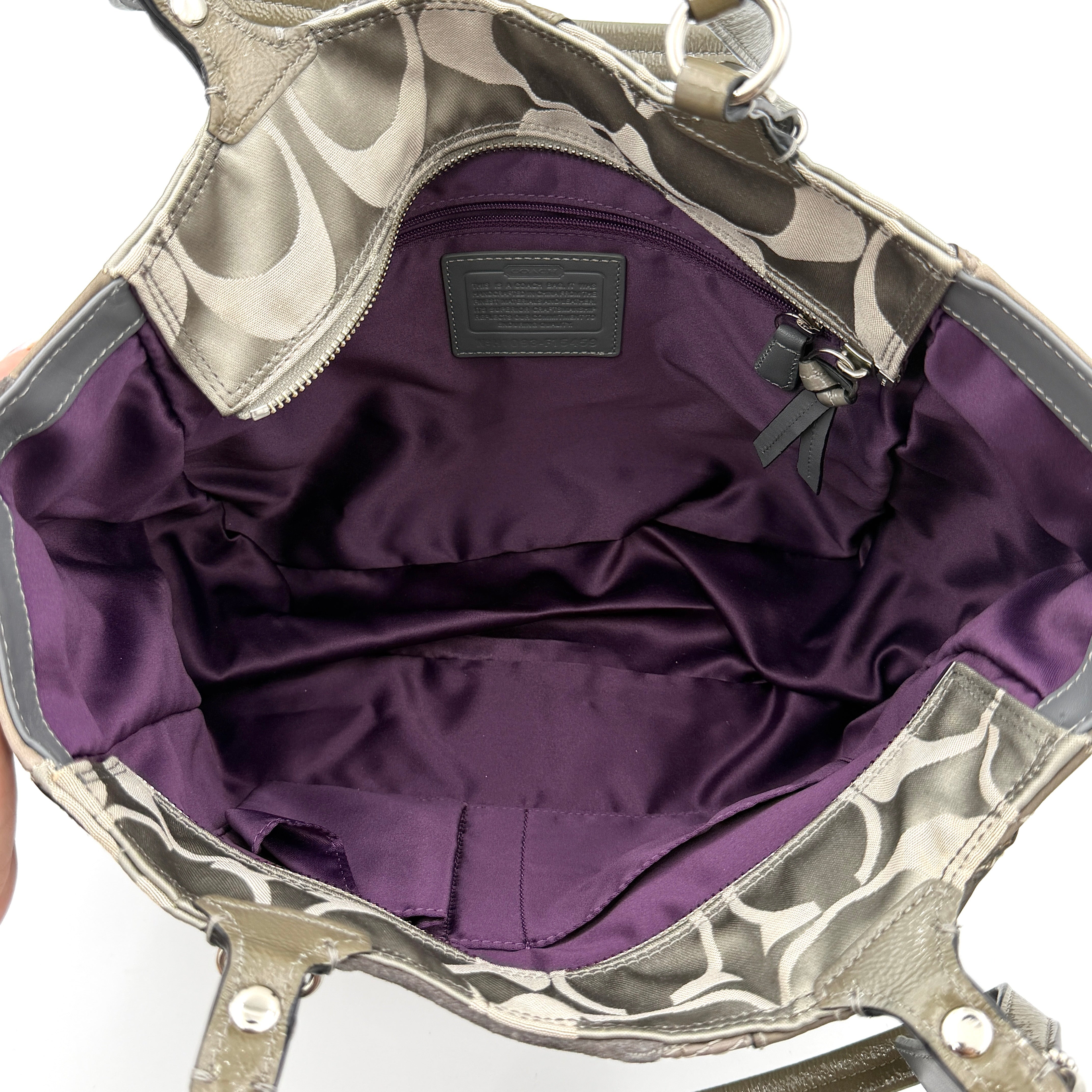 Coach Y2K patchwork tote in grey tones with jacquard, suede, and ocelot-print panels, shown with double handles and signature tag.