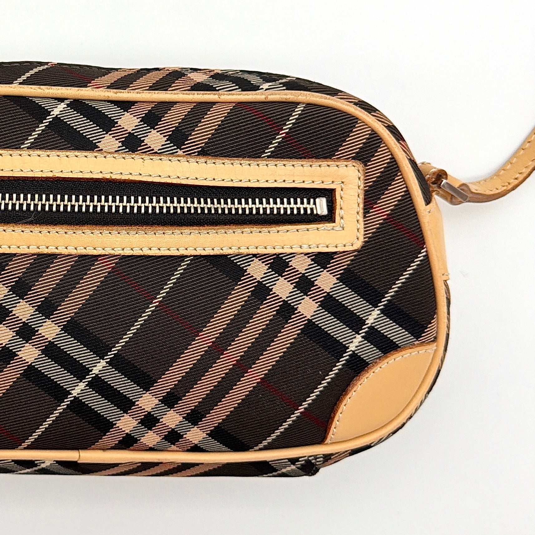 Burberry Blue Label Nova Check crossbody bag with tan leather trim and heart charm, styled on a white background.