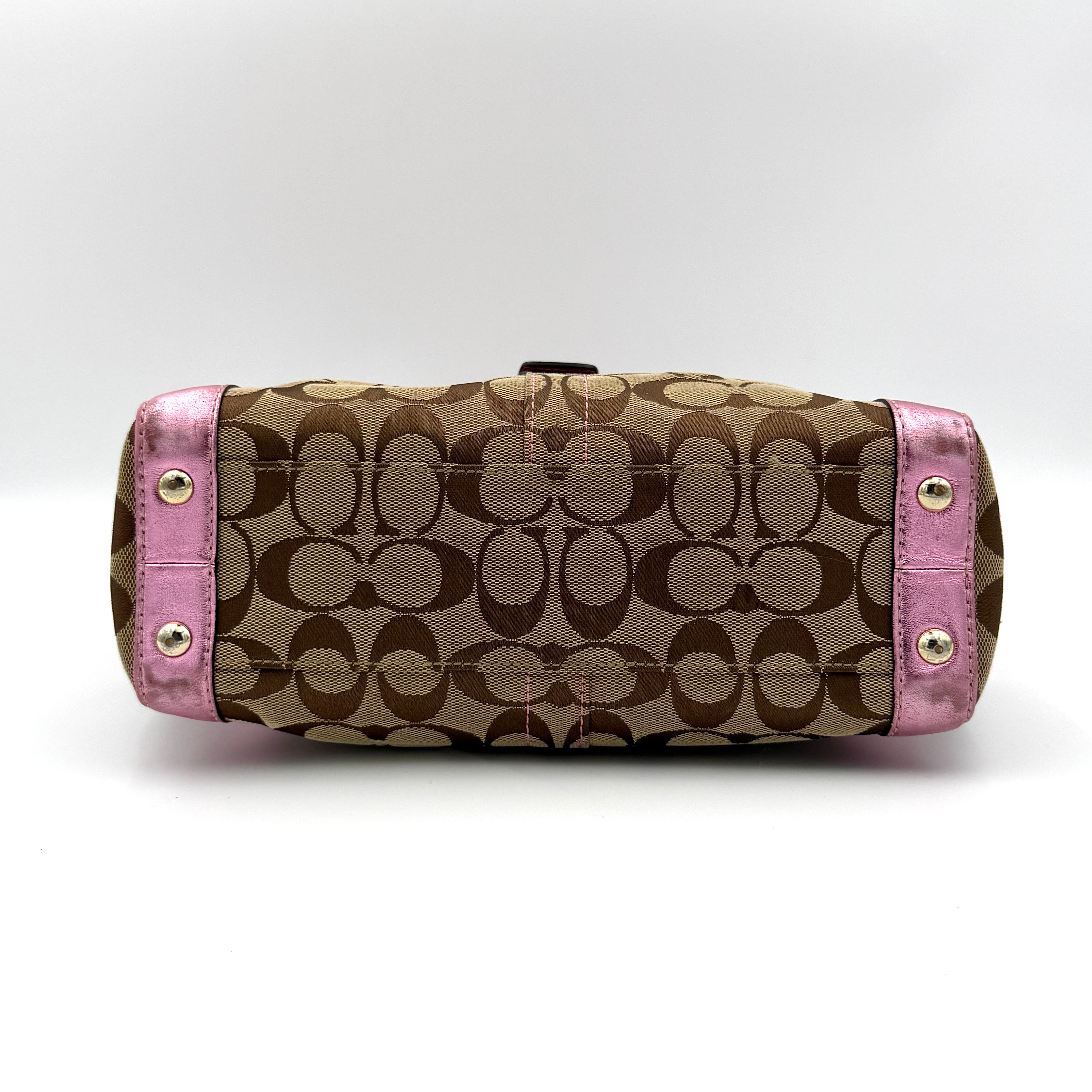 Coach Soho Buckle Tote featuring baby pink metallic leather trim and beige signature jacquard canvas with gold-tone hardware.