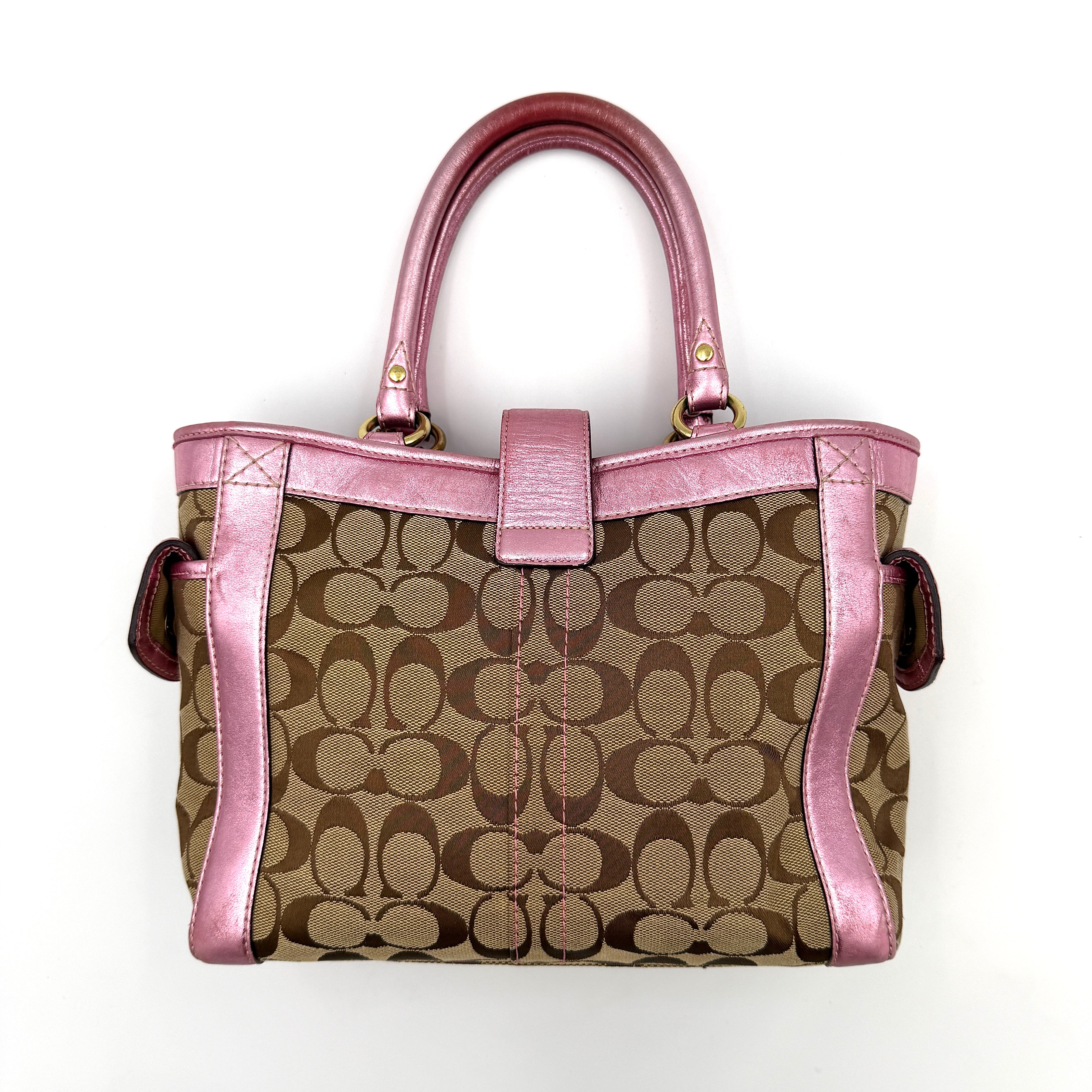 Coach Soho Buckle Tote featuring baby pink metallic leather trim and beige signature jacquard canvas with gold-tone hardware.
